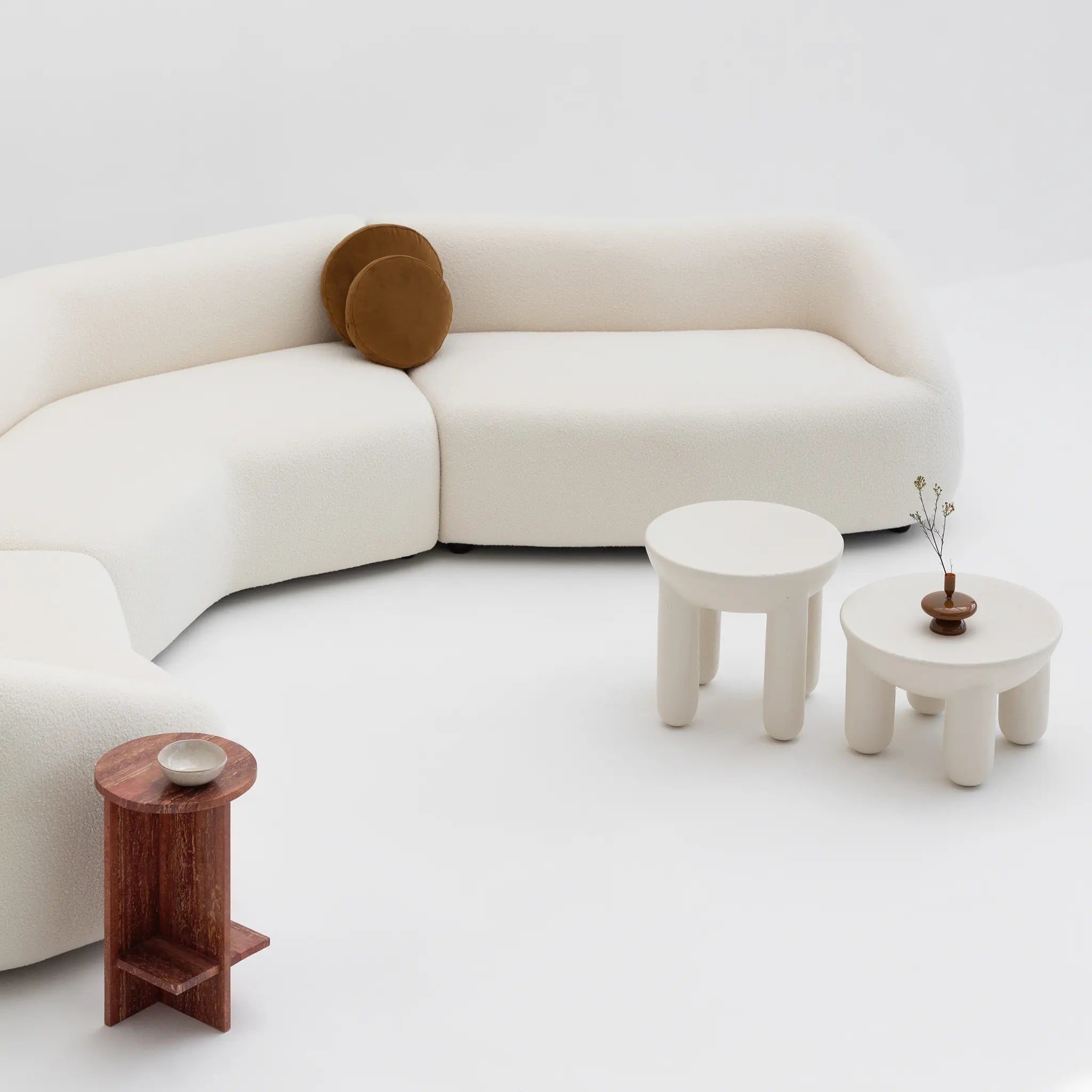 Circle coffee table holding books and decor in bright minimalist home