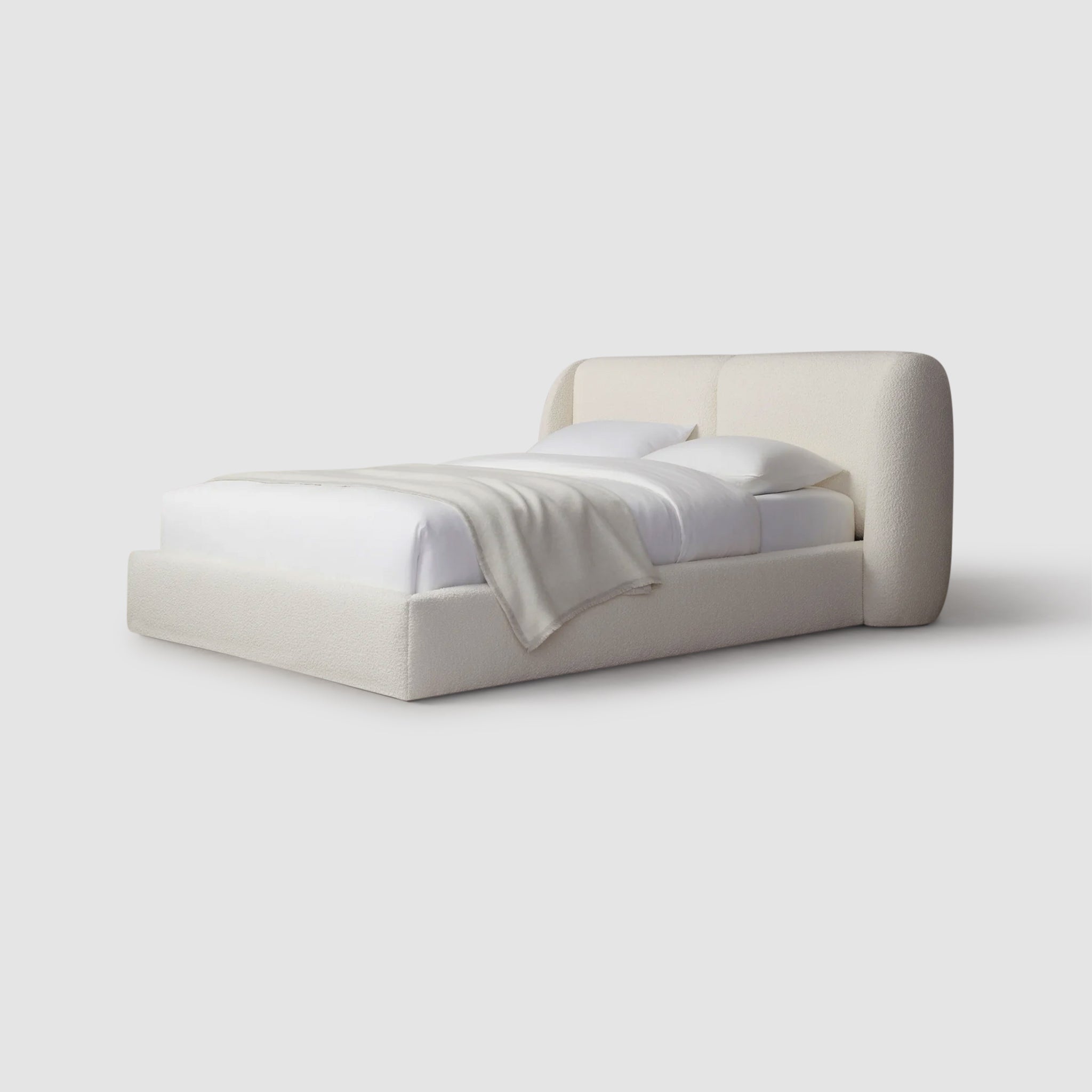 Relax in luxury with the Ashley platform bed featuring a plush white blanket. Luxury bedding.