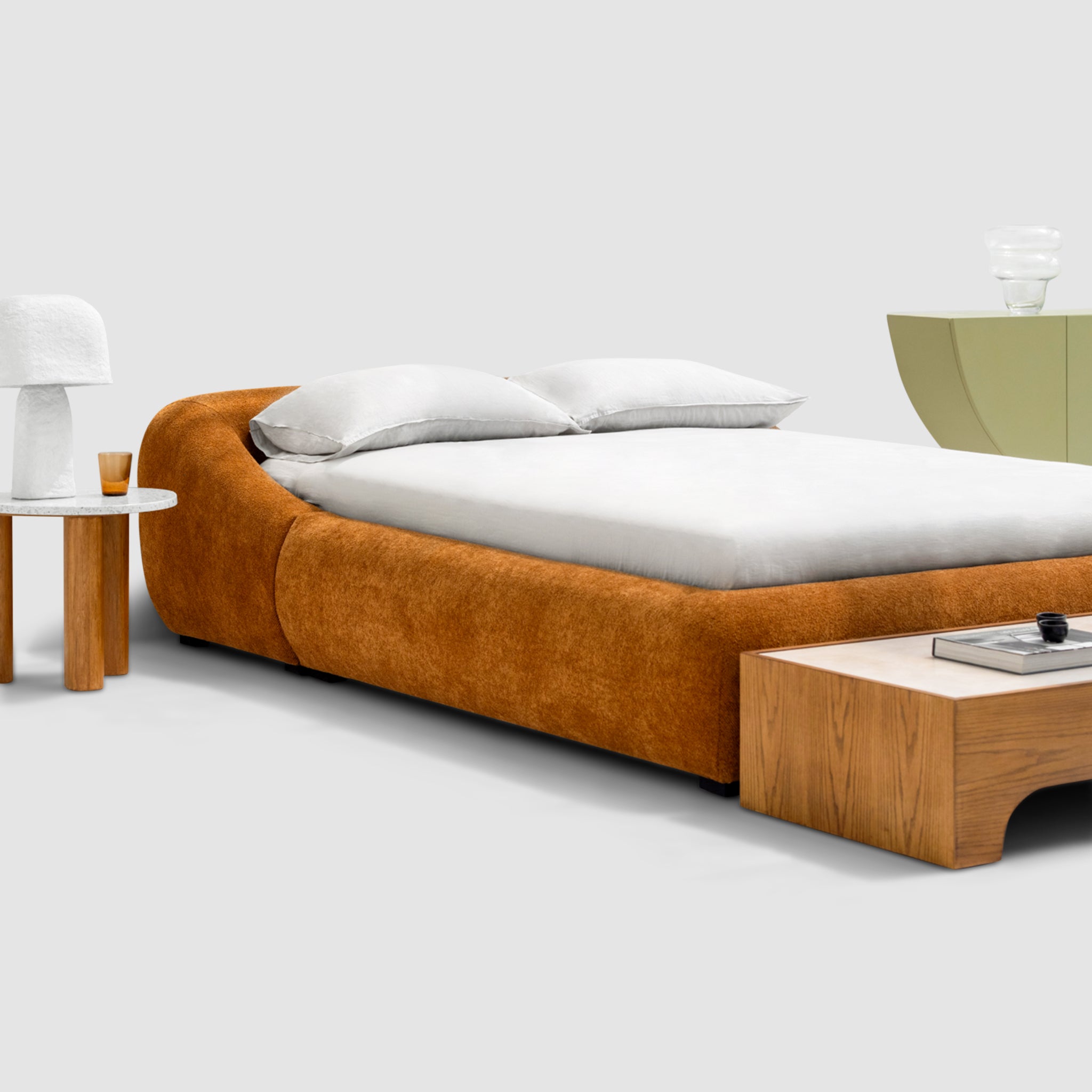 Sleek, charcoal gray platform bed with a minimalist button-tufted headboard. The Alain Bed by Klettkic is crafted from solid wood for a touch of modern luxury in a light-filled bedroom. buy beds in Dubai