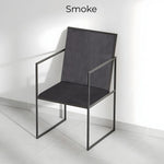 Load image into Gallery viewer, The Joelle dining chair with iron legs, adding an industrial edge to a bright and airy dining space.