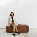 Load image into Gallery viewer, Stylish lifestyle image featuring a woman with Sebastian Coffee Table and Italian ottoman.