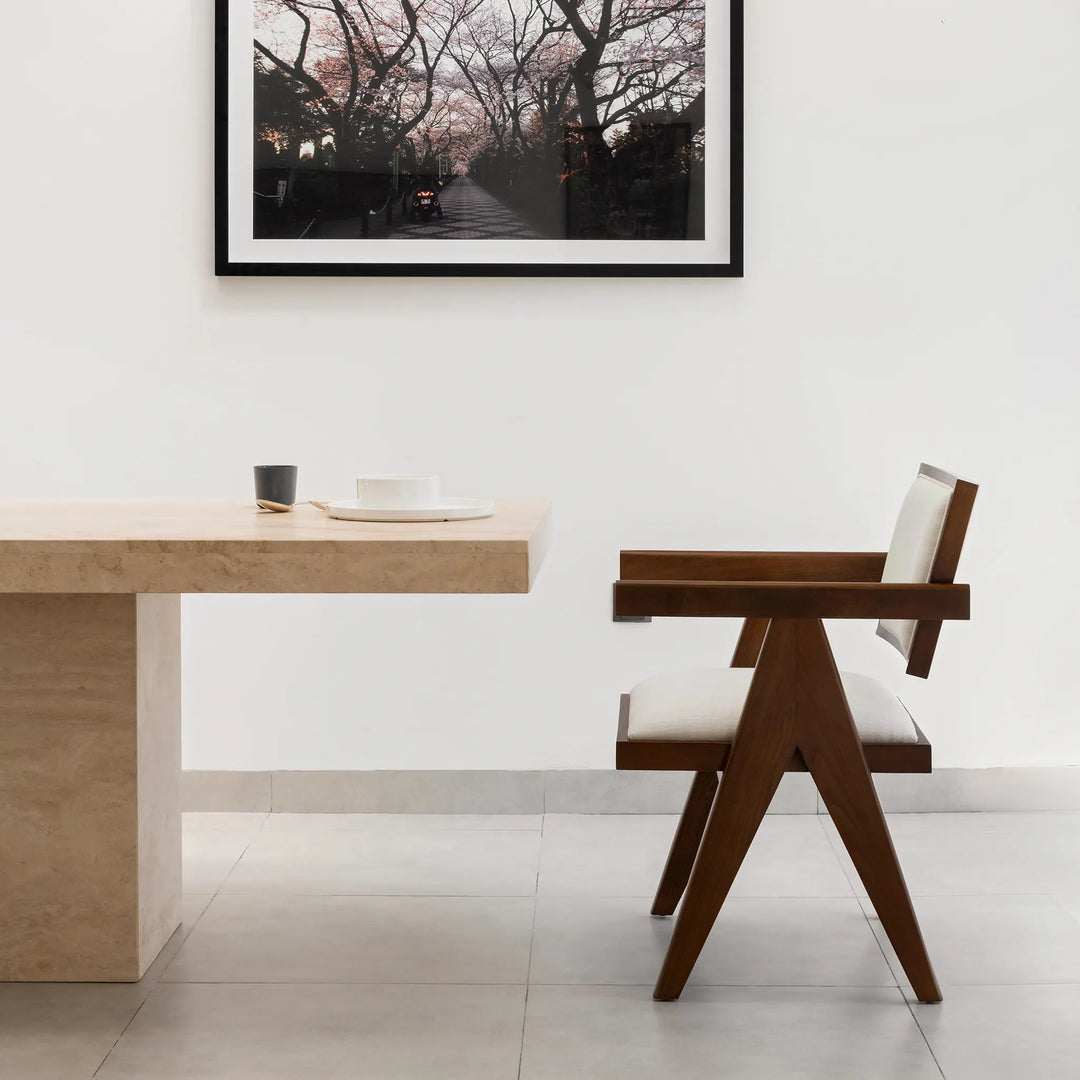 The Pierre wood frame dining chair styled in a bright dining room, bringing elegance and comfort together.