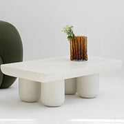 The Berta Coffee Table in white, placed in a modern living room with bright accents, creating a welcoming atmosphere.