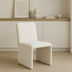 Load image into Gallery viewer, The Carl two leg chair adding a touch of modern elegance to a chic living room setup.
