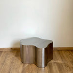 Load image into Gallery viewer, A beautiful, medium-sized steel coffee table in a cozy, contemporary setting, perfect for entertaining guests.

