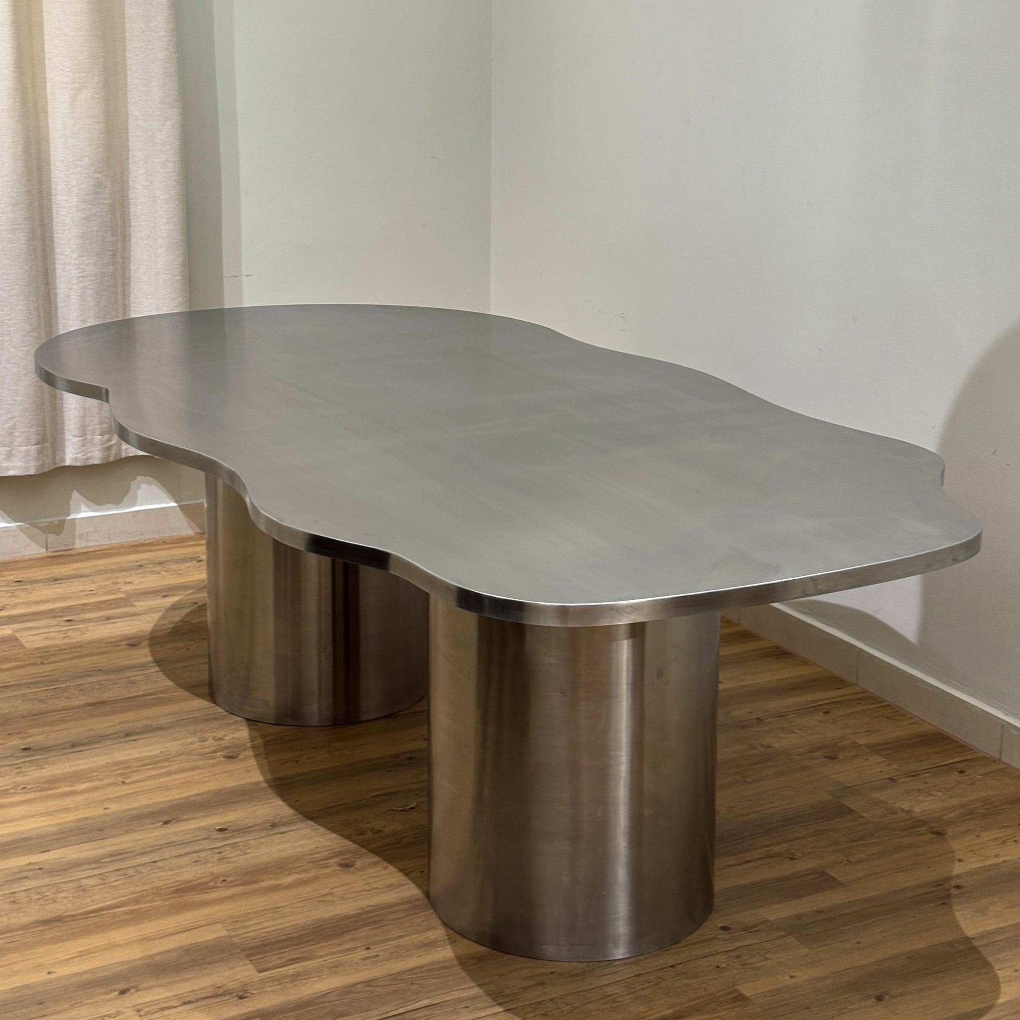 The Victoria Curvy Dining Table in Stainless Steel