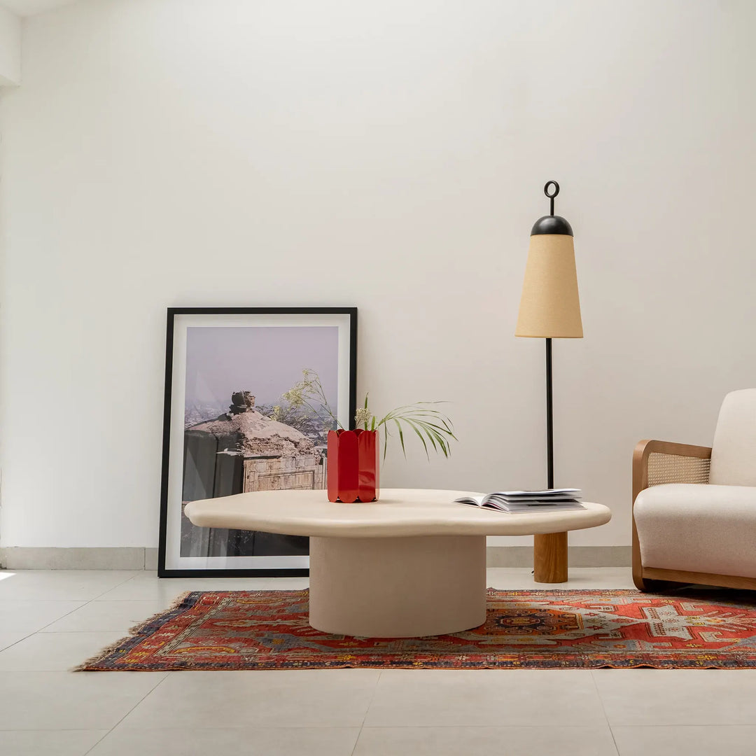 Neutral-toned living room featuring The Jamie Coffee Table, blending sculptural aesthetics with practicality – a round wooden coffee table Dubai interiors can easily embrace.