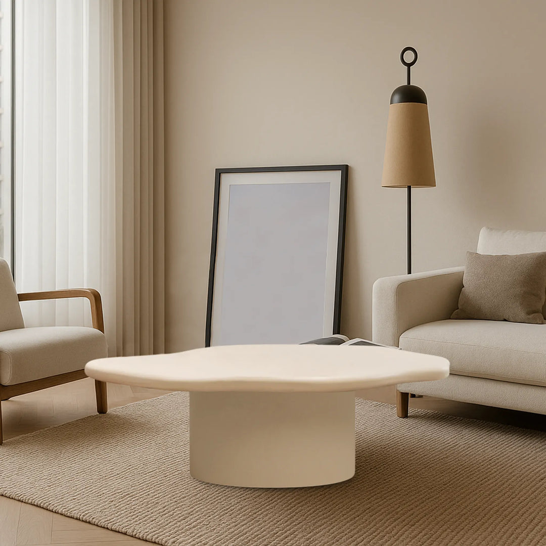 The Jamie Coffee Table pops against dark hardwood floors, combining soft tones with a glass top – a stylish and affordable round coffee table UAE residents will find versatile.