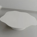 Load image into Gallery viewer, The Jamie Coffee Table shown on a grey backdrop, featuring a polished micro plaster finish and round glass surface – a standout modern glass coffee table UAE shoppers will appreciate.
