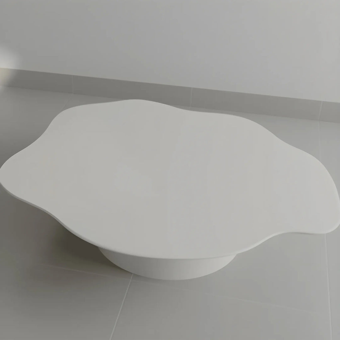 The Jamie Coffee Table shown on a grey backdrop, featuring a polished micro plaster finish and round glass surface – a standout modern glass coffee table UAE shoppers will appreciate.