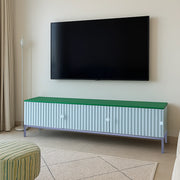 The Rina white TV cabinet with storage, enhancing the decor of a bright, airy living room.