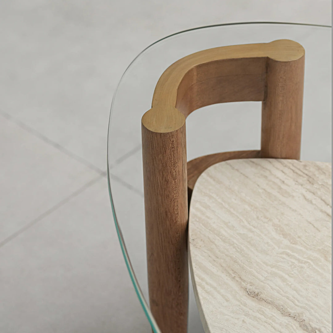 Detail view of the tempered glass surface on The Scott Coffee Table, highlighting the fine craftsmanship of its wooden base – a clear glass coffee table with refined elegance.