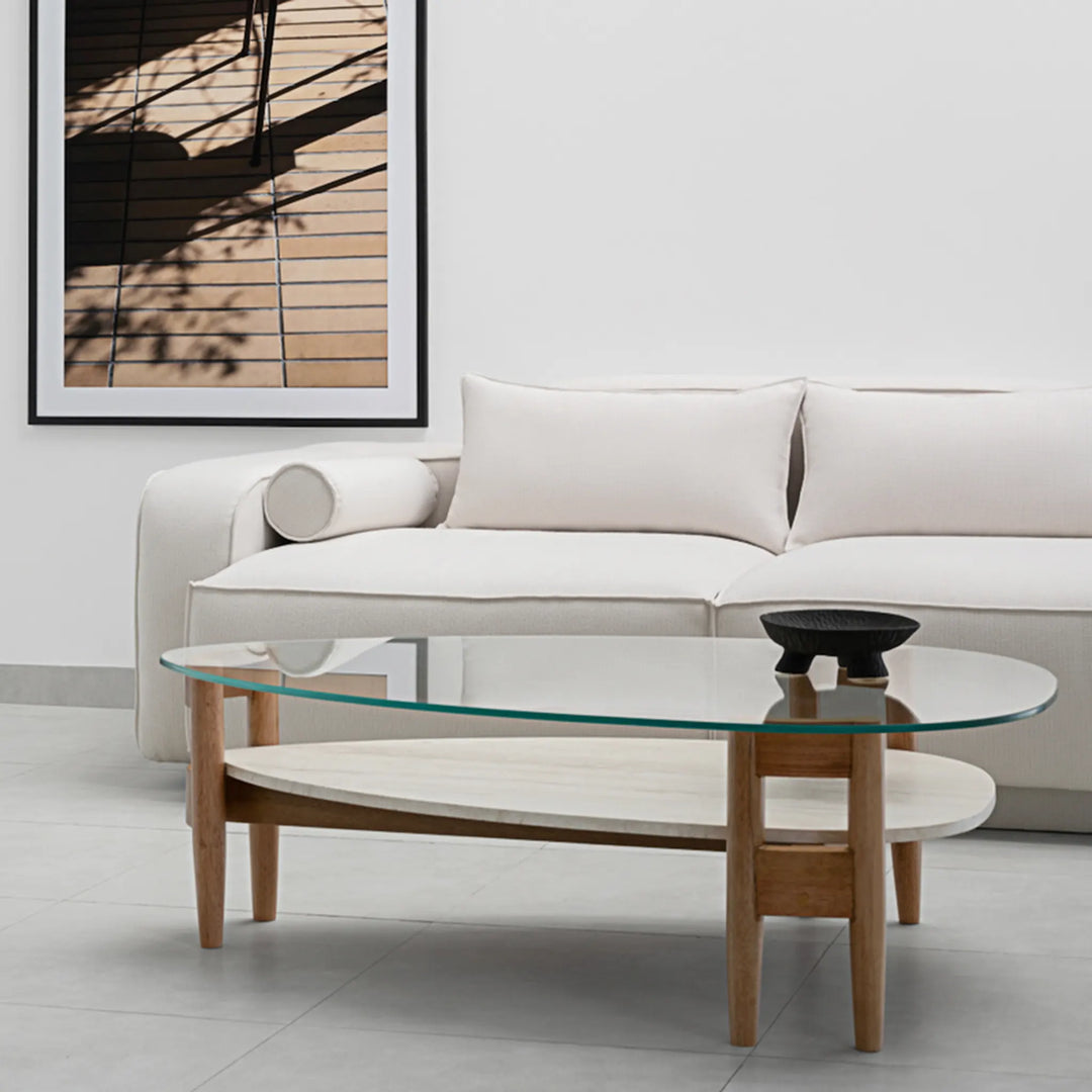 The Scott Coffee Table styled in a cozy living room, showcasing its elegant round glass top and rustic wood base – ideal as a glass top center table for modern homes."