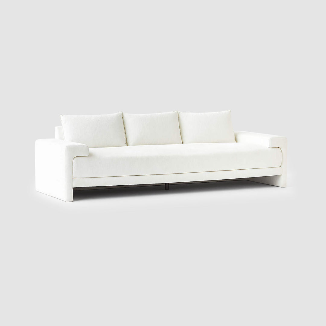 The Sylvia modern white sofa with seamless texture, highlighted on a grey backdrop for contrast.
