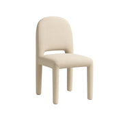 The Shelly fabric dining chair in a neutral grey setting, emphasizing its refined and modern aesthetic.