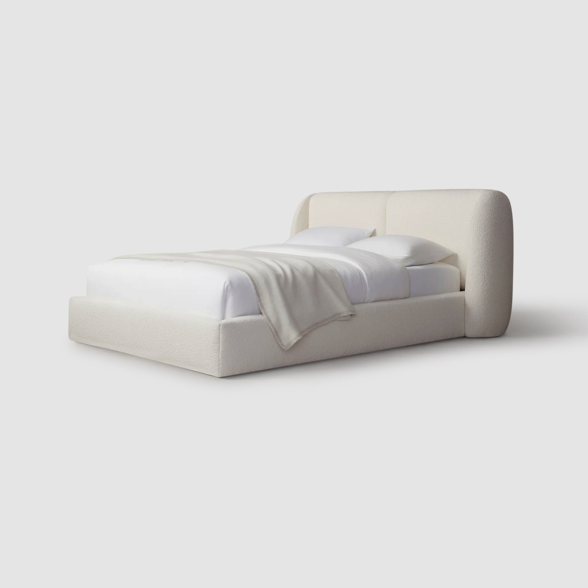 Relax in luxury with the Ashley platform bed featuring a plush white blanket.