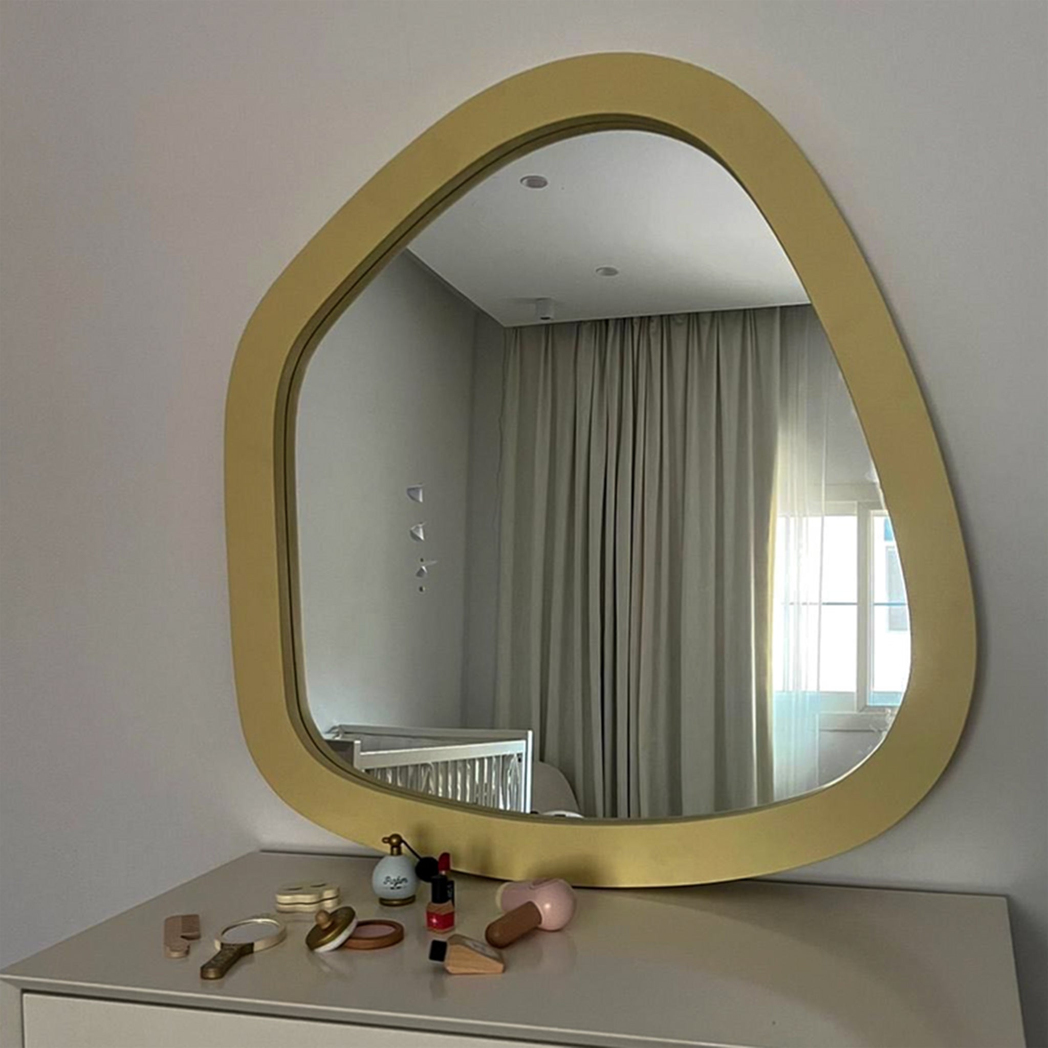 Modern wall mirror showcasing a bright window.