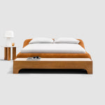 Load image into Gallery viewer, Sleek, charcoal gray king-size platform bed with a minimalist button-tufted headboard rests on a light wood floor. The Alain Bed by Klettkic is crafted from solid wood for a touch of modern luxury in a minimalist bedroom. buy beds in Dubai
