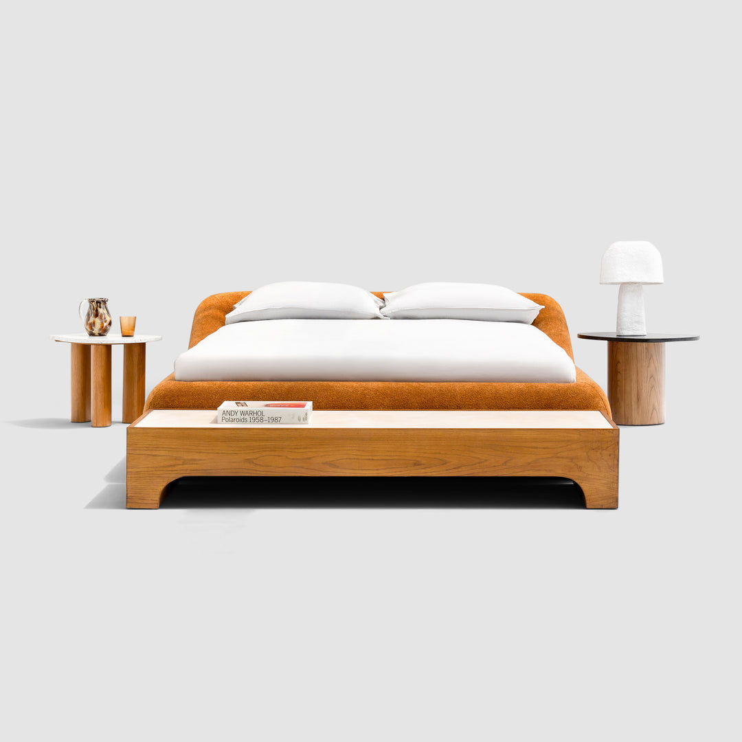 buy beds in Dubai Sleek, charcoal gray king-size platform bed with a minimalist button-tufted headboard complements a minimalist bedroom with a light wood floor. The Alain Bed by Klettkic is crafted from solid wood for a touch of modern luxury.