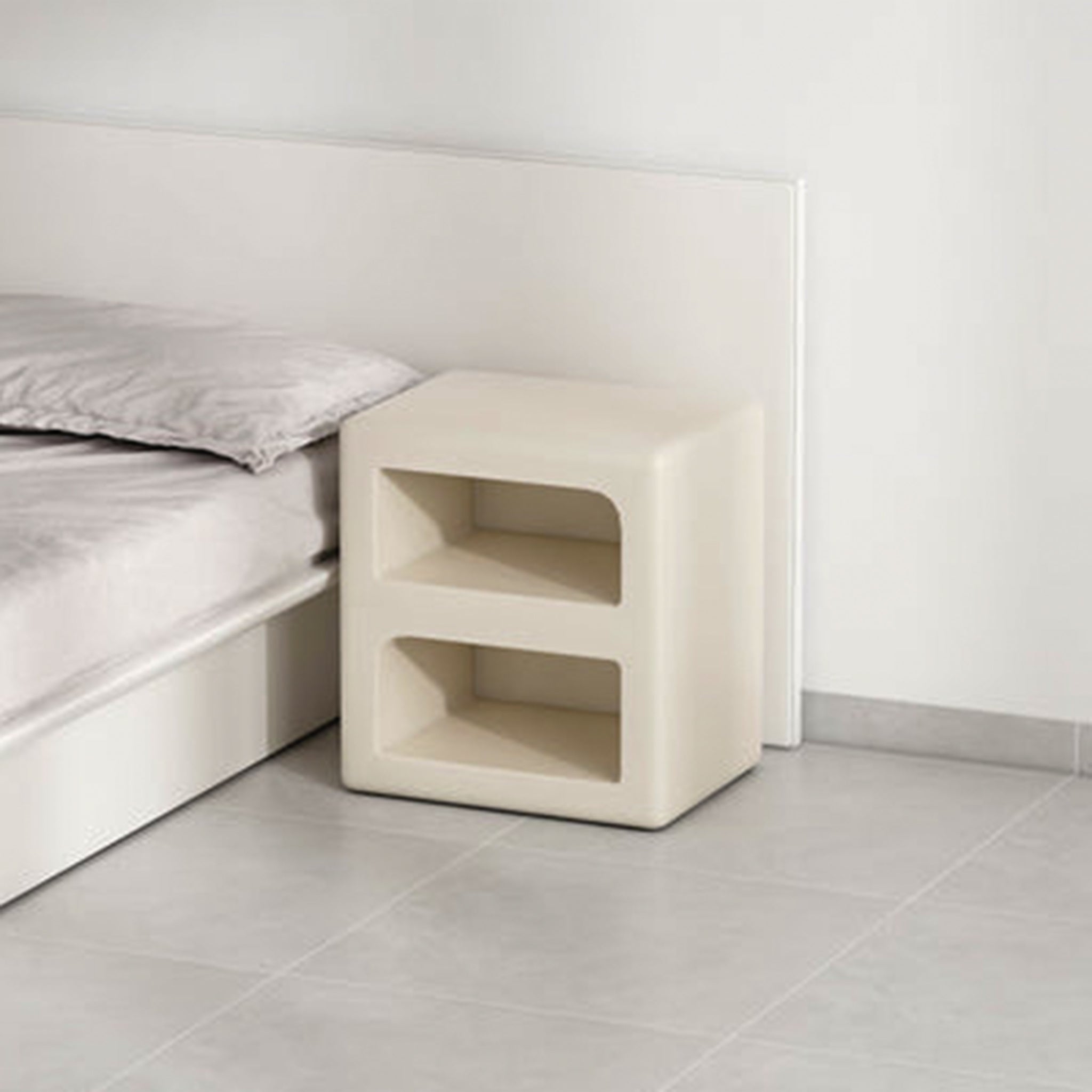 Side table with a built-in magazine rack for keeping reading materials organized.