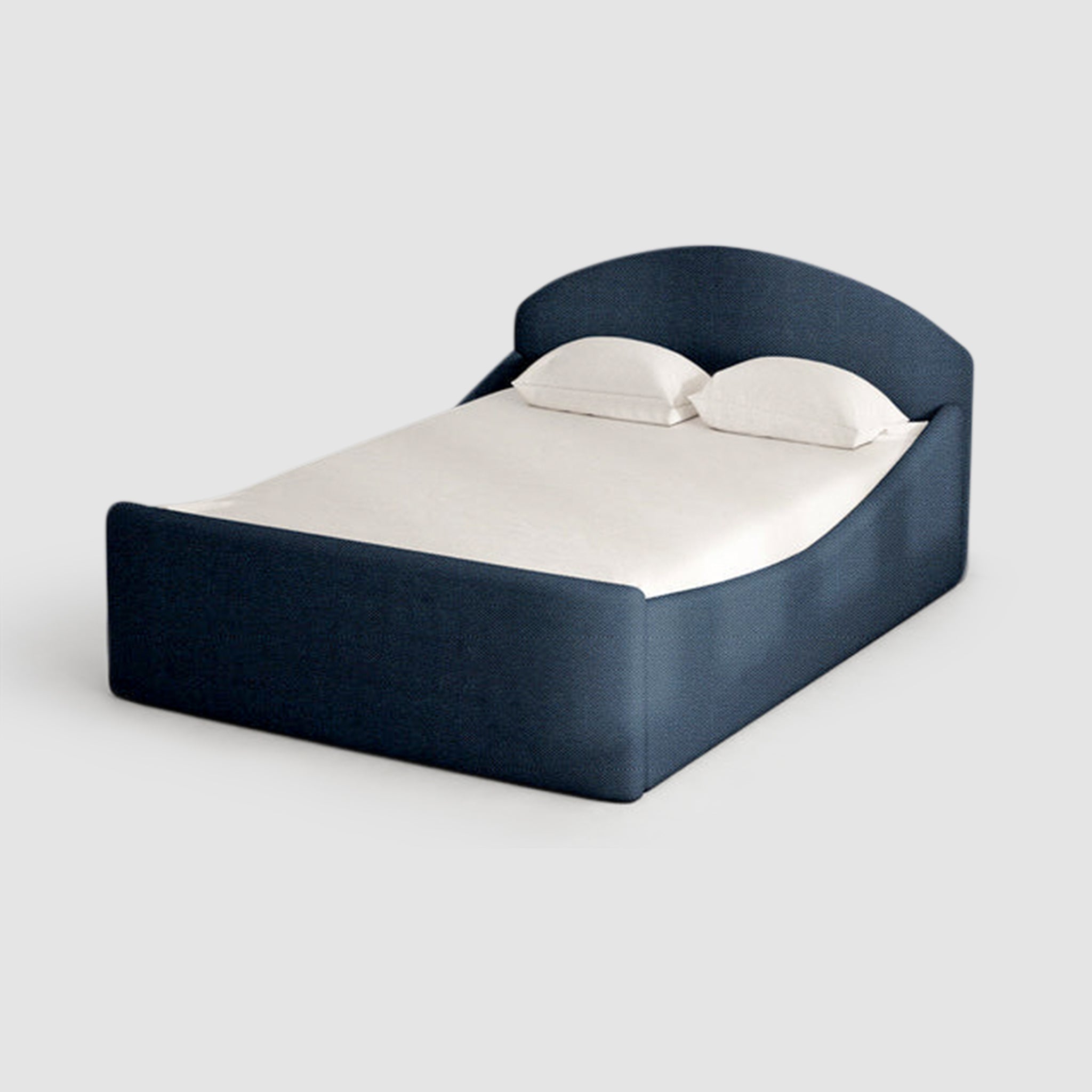 The Alice Bed in navy blue with curved headboard, elegant and modern bedroom decor