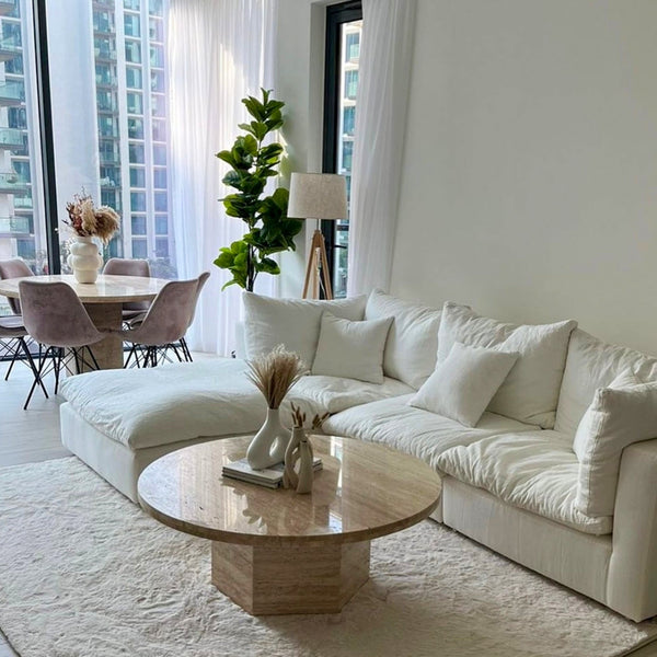 The Avis Feather Cloud Couch with ottoman, styled as a centerpiece in a luxury living room.