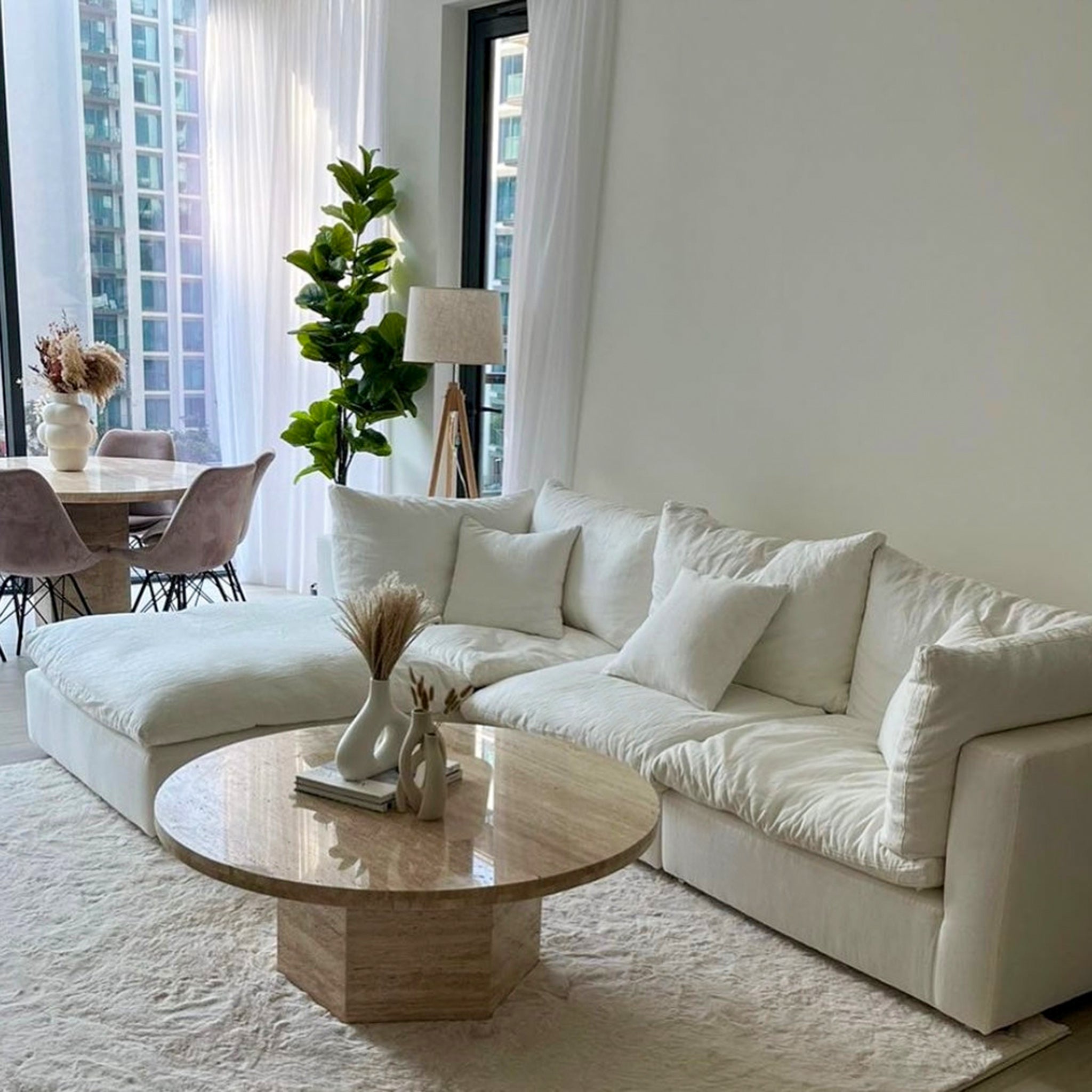 White curved couch with marble coffee table in living room . Top Quality cloud couch life style view