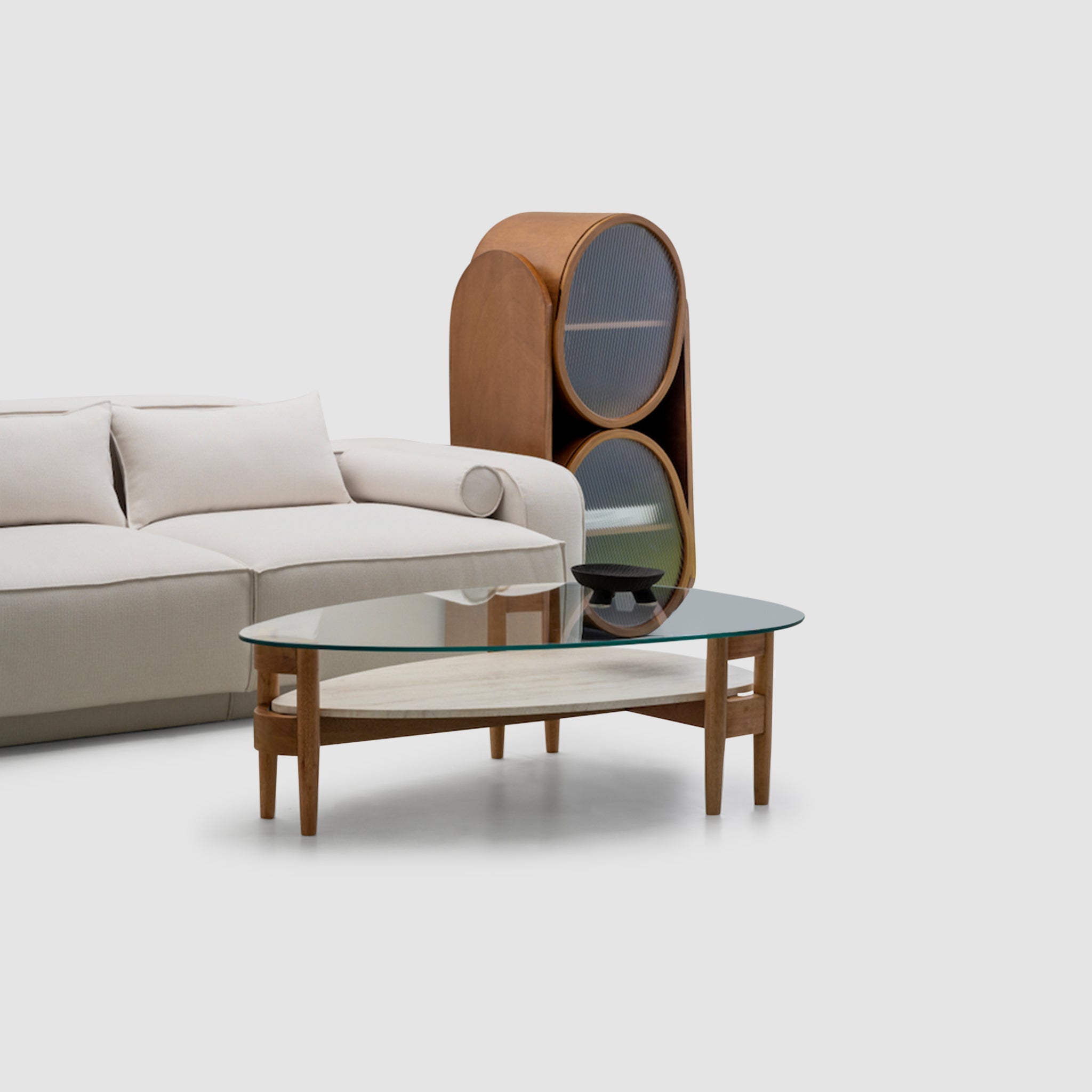 White L-shaped sofa anchors a conversation area in this mid-century modern living room with a brown leather ottoman and a black lamp on a round wooden table.