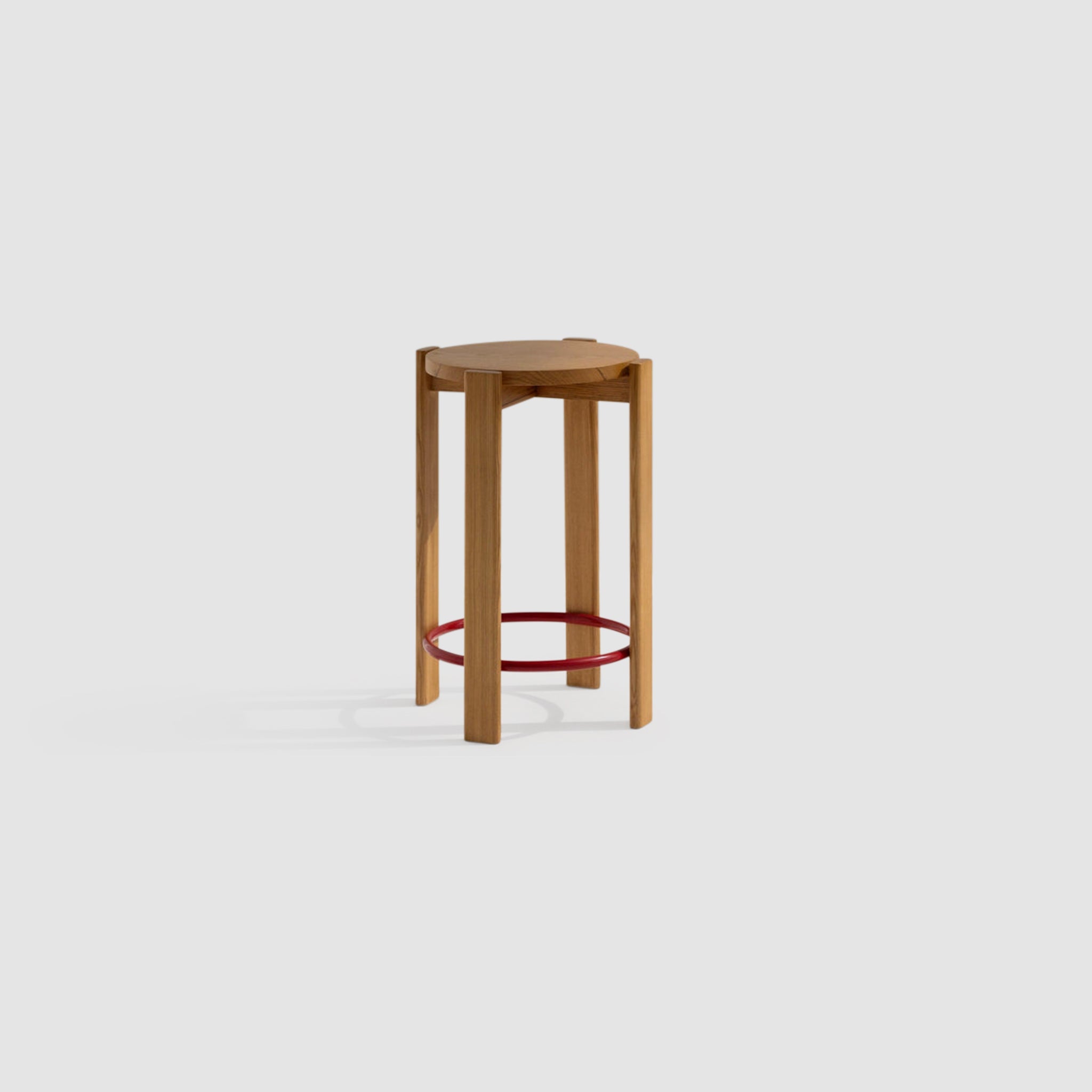 Wooden bar stool with a round seat and a red circular footrest