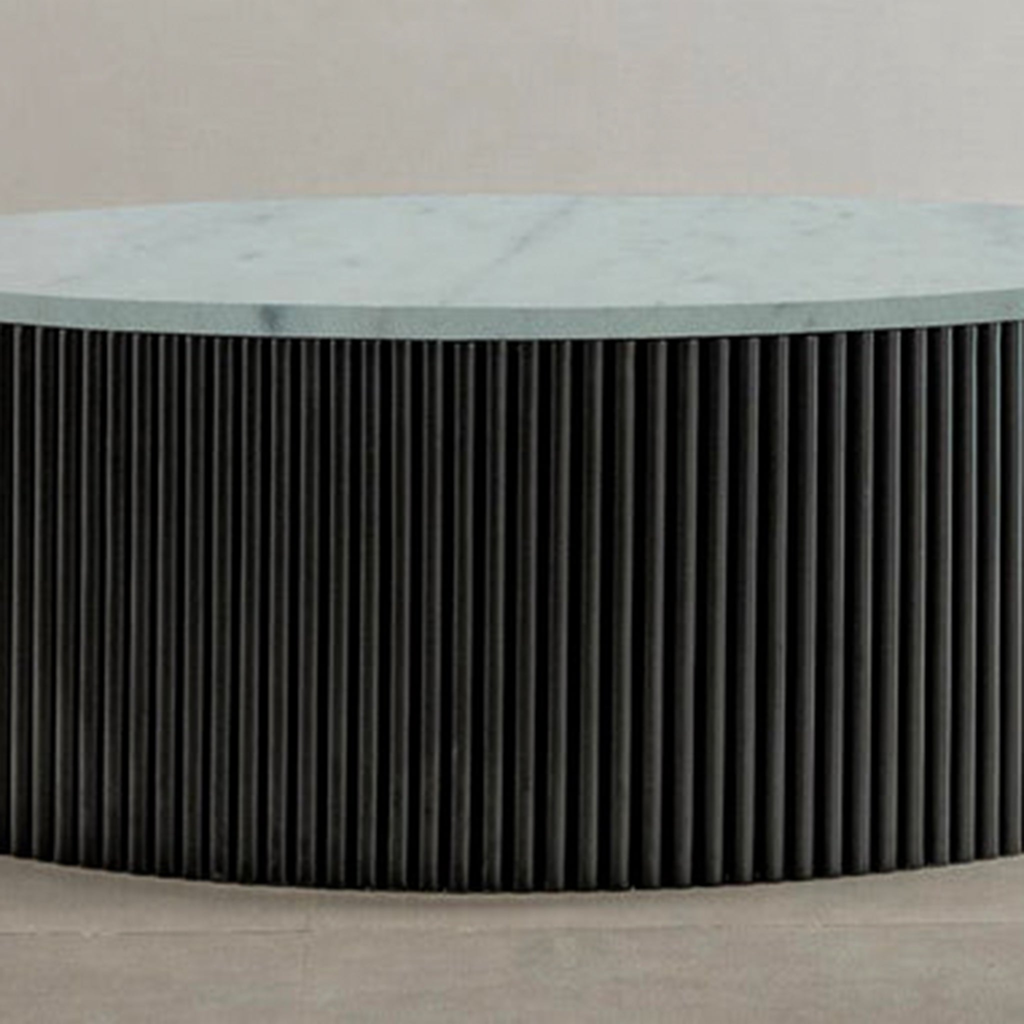 "Elegant coffee table with ribbed base and smooth green top"