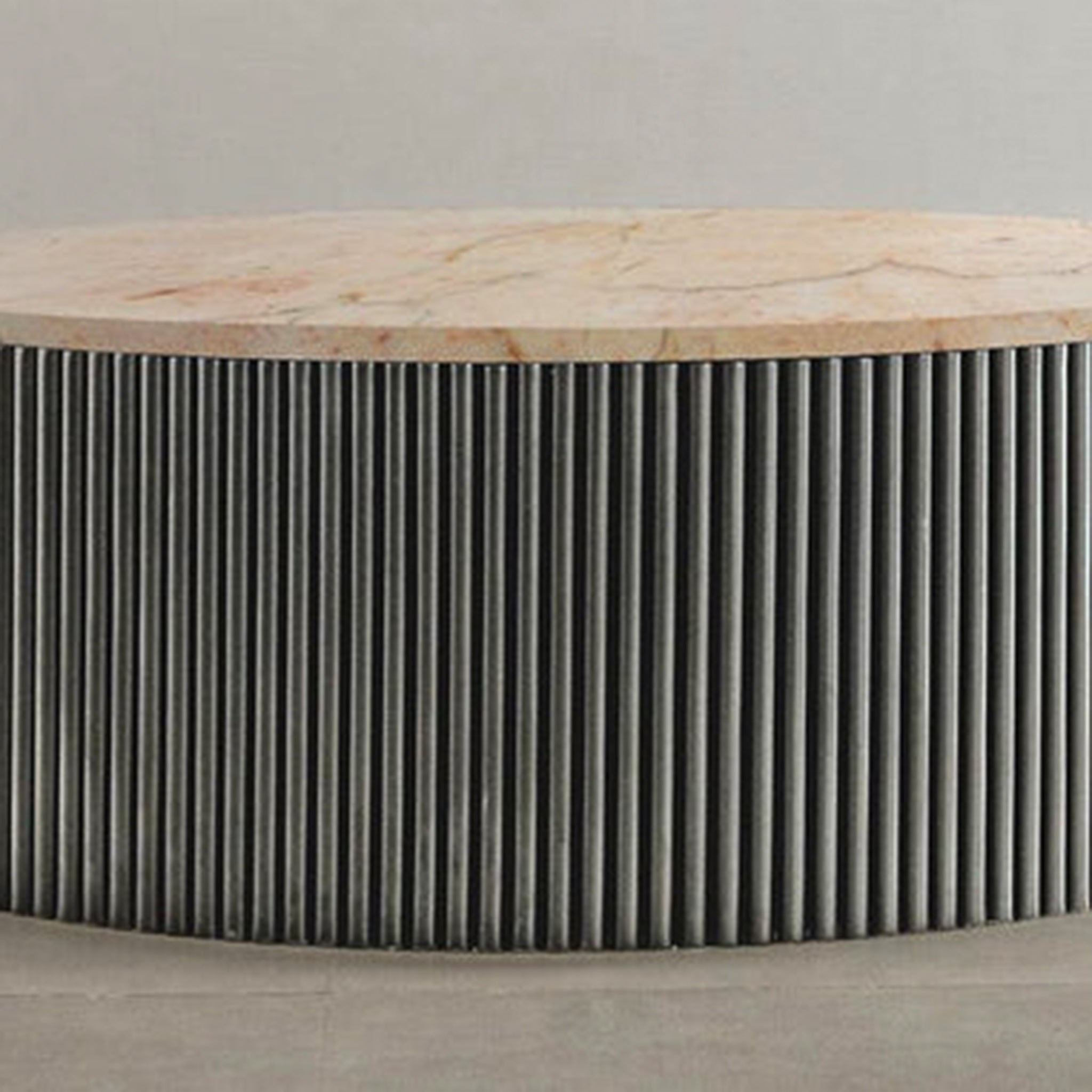 "Minimalist round table with ribbed sides and smooth top"