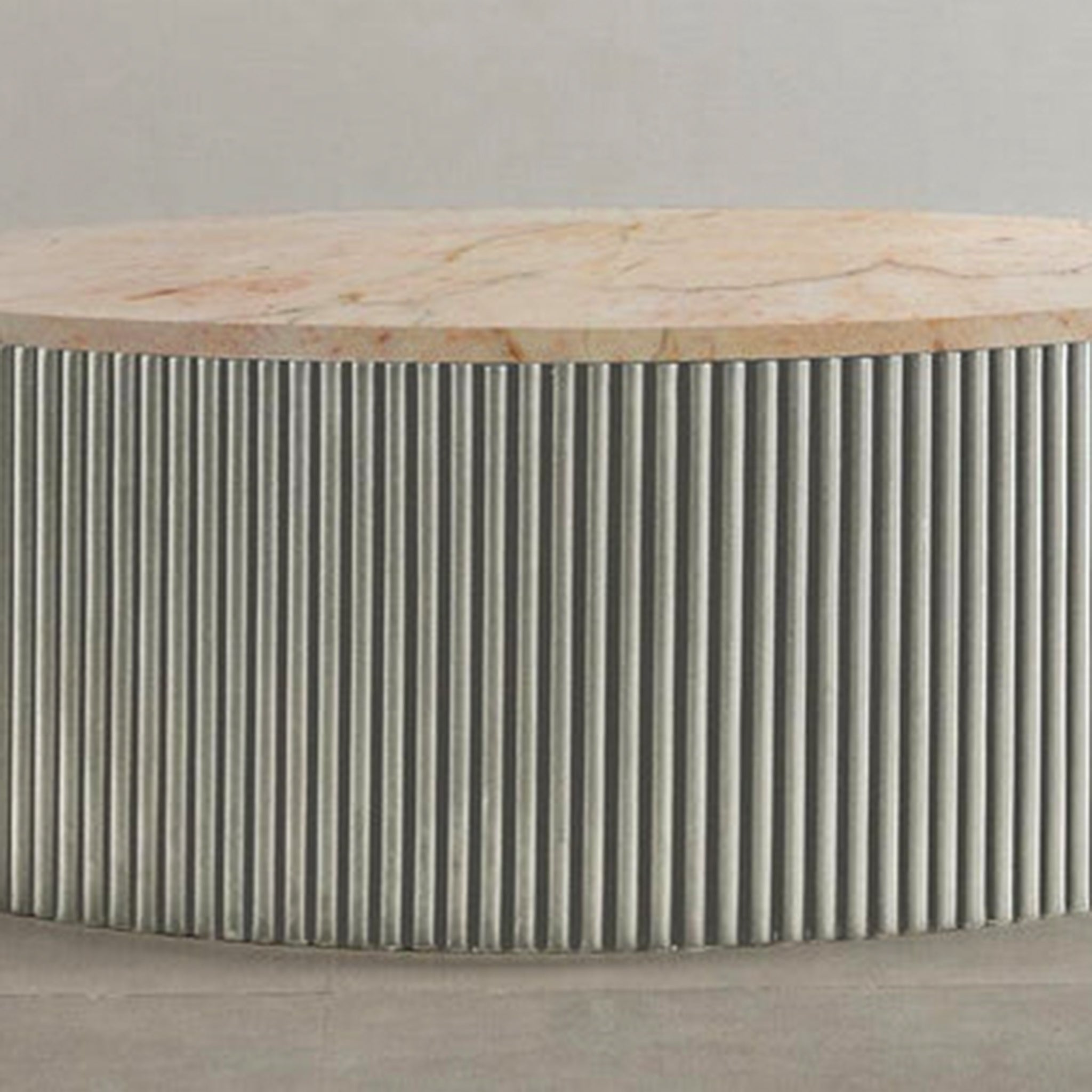 "Minimalist circular coffee table with unique ribbed detailing"