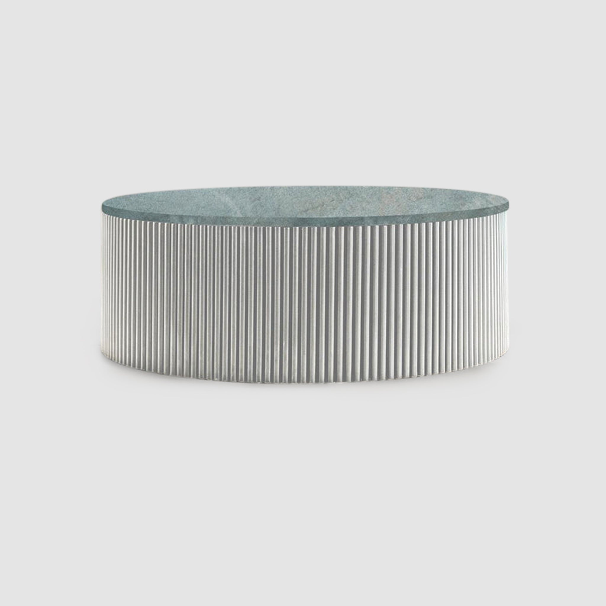 "Modern round coffee table with ribbed detailing"