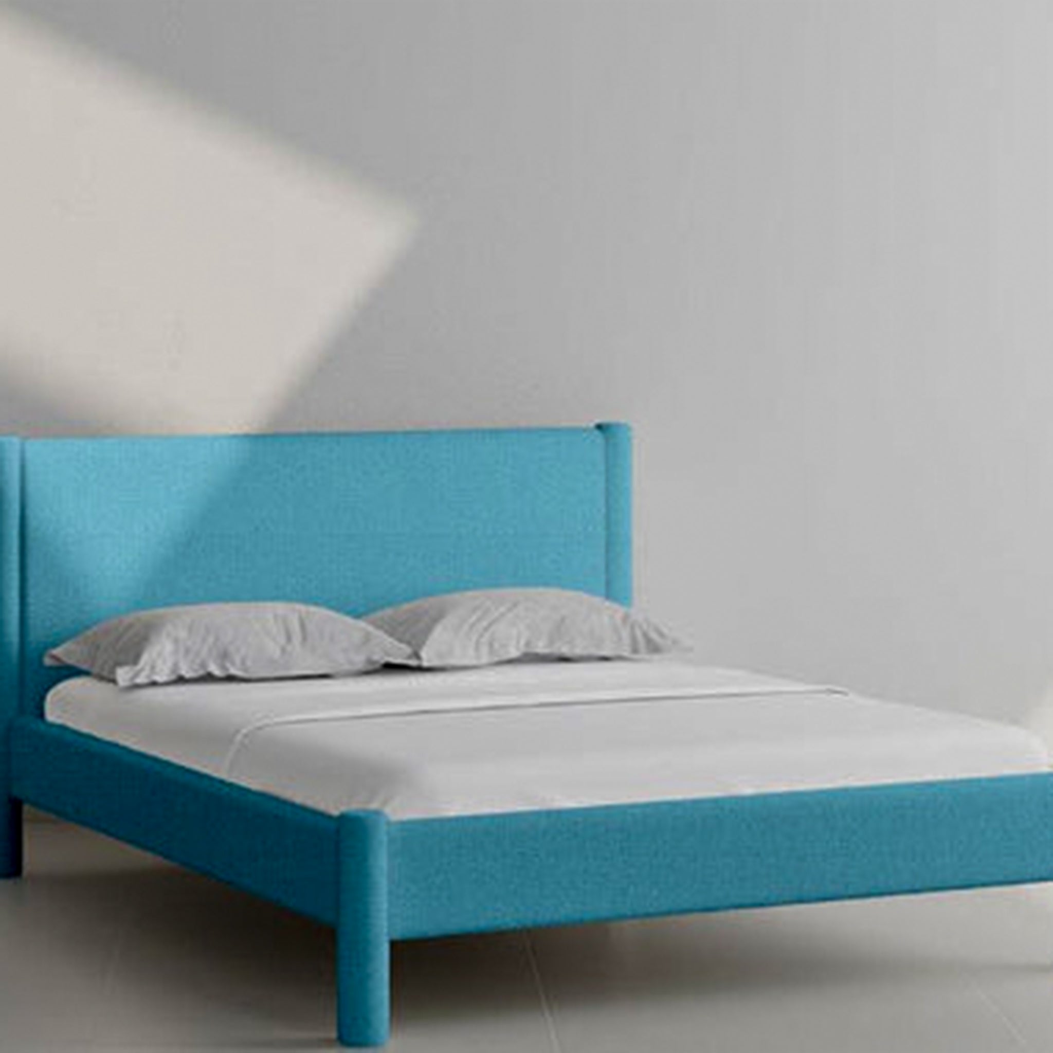 Stylish and sturdy Carrie Bed featuring a turquoise upholstered headboard.
