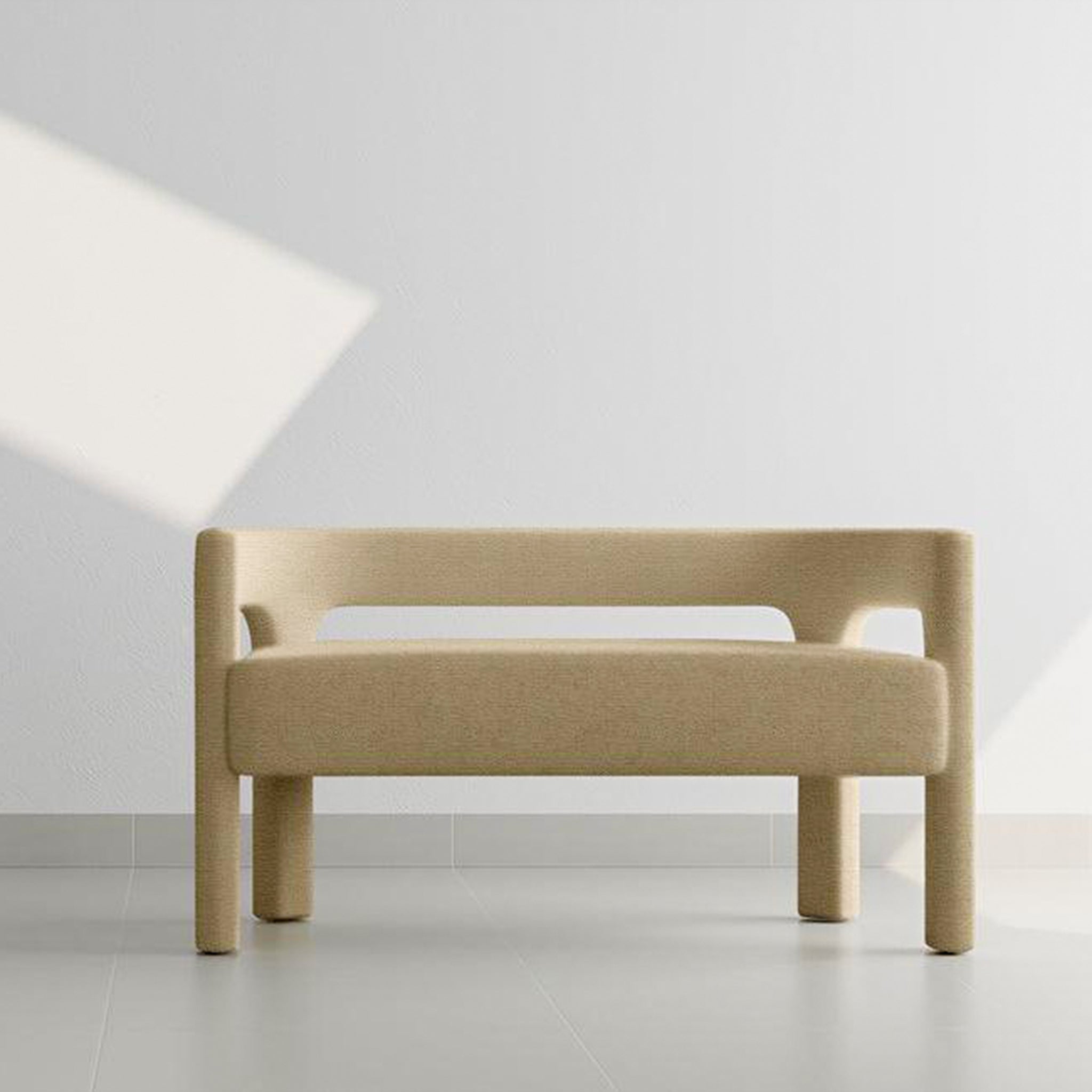 Modern beige two-seater sofa against a minimalist white wall