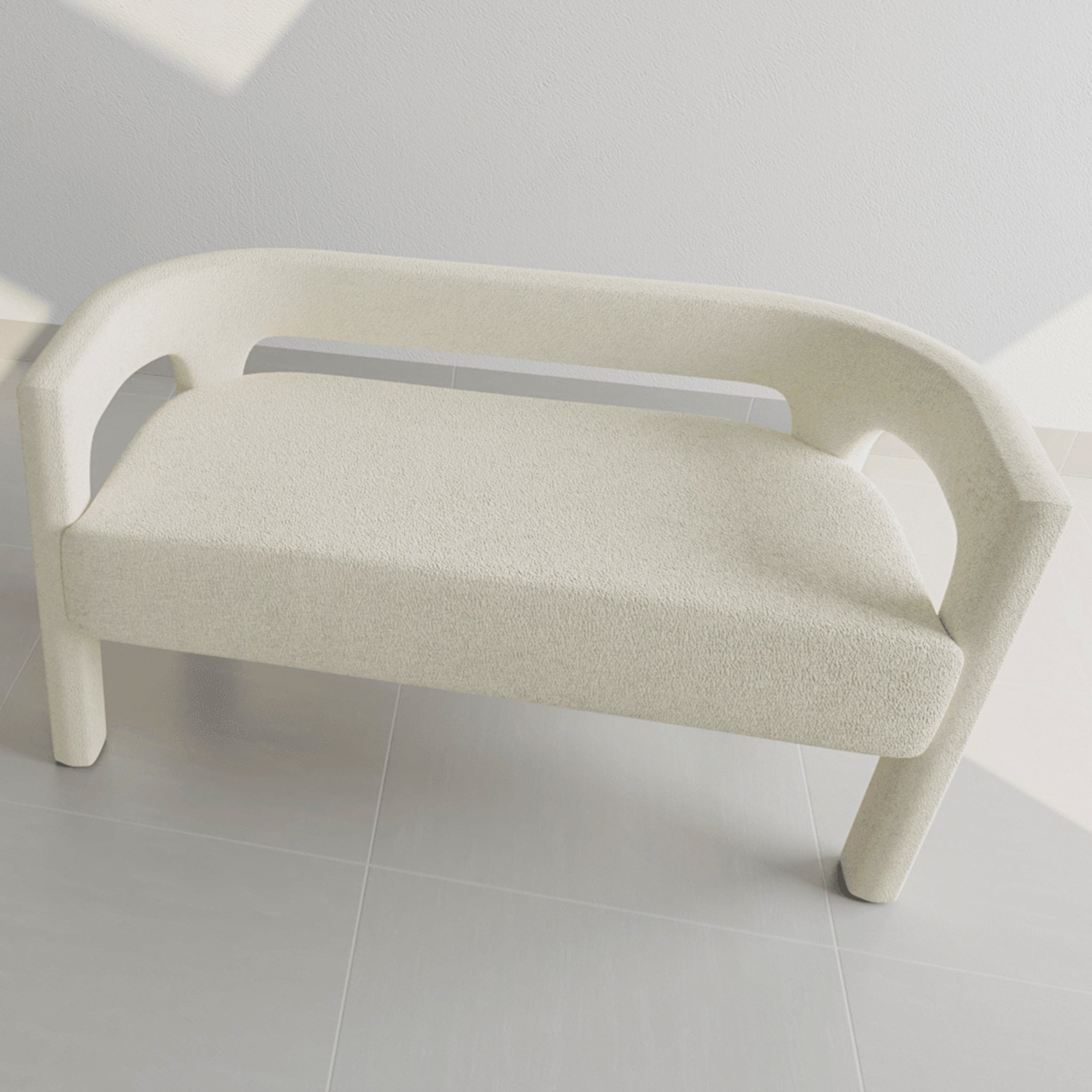 Top view of a sleek, contemporary cream two-seater bench with curved armrests in a bright, minimalist setting
