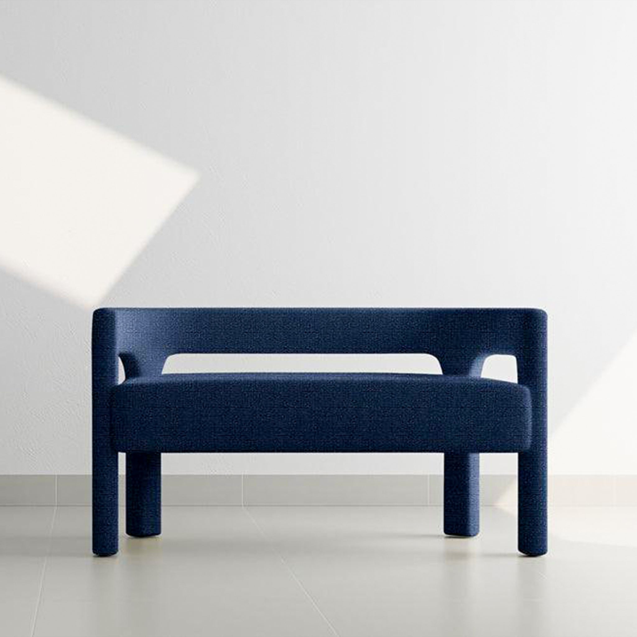 Front view of a stylish blue two-seater sofa in a modern, minimalist room with soft natural light