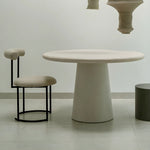 Load image into Gallery viewer, The Claudia round dining chair positioned around a modern dining table, enhancing a sophisticated dining room.
