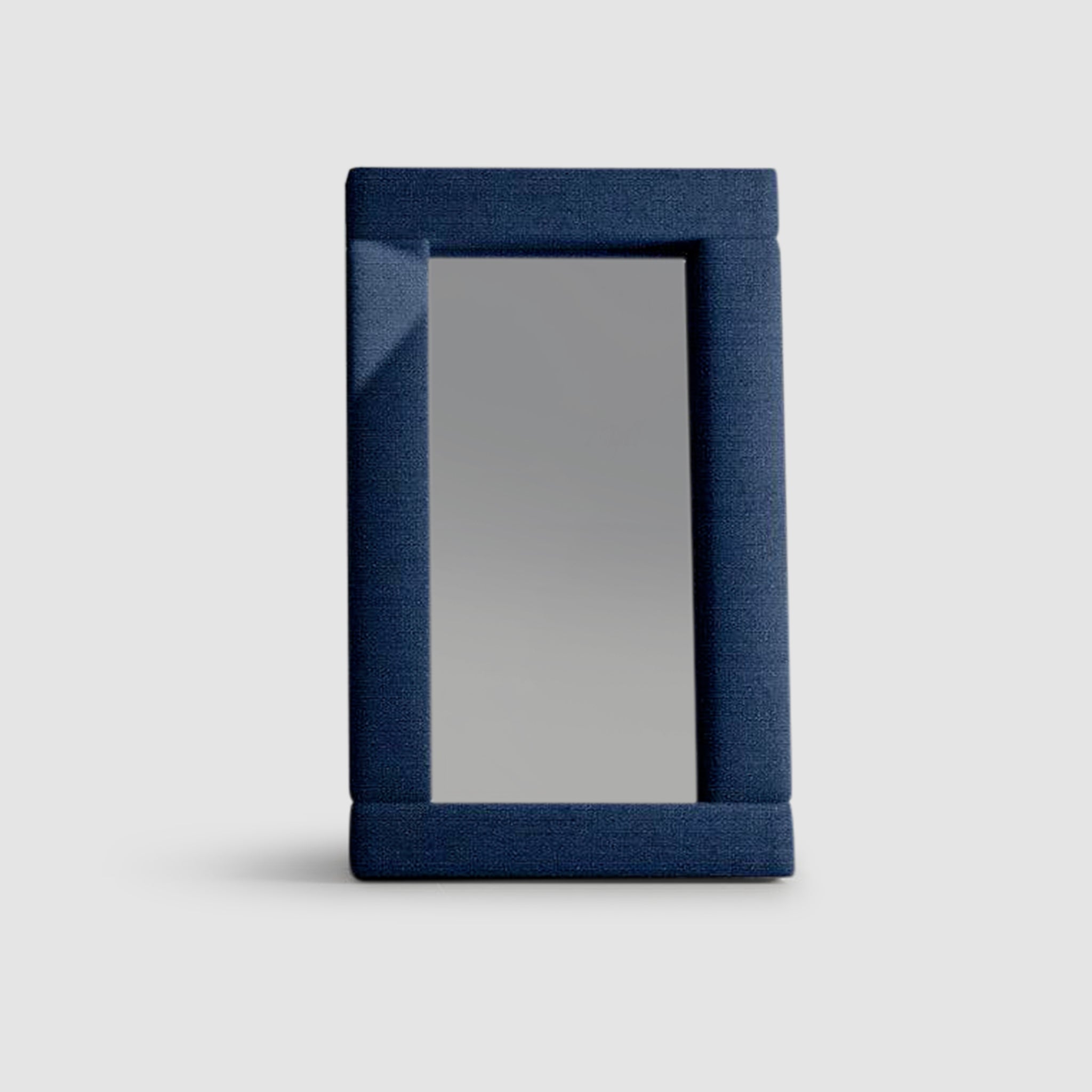 Rectangular mirror with a dark blue padded frame