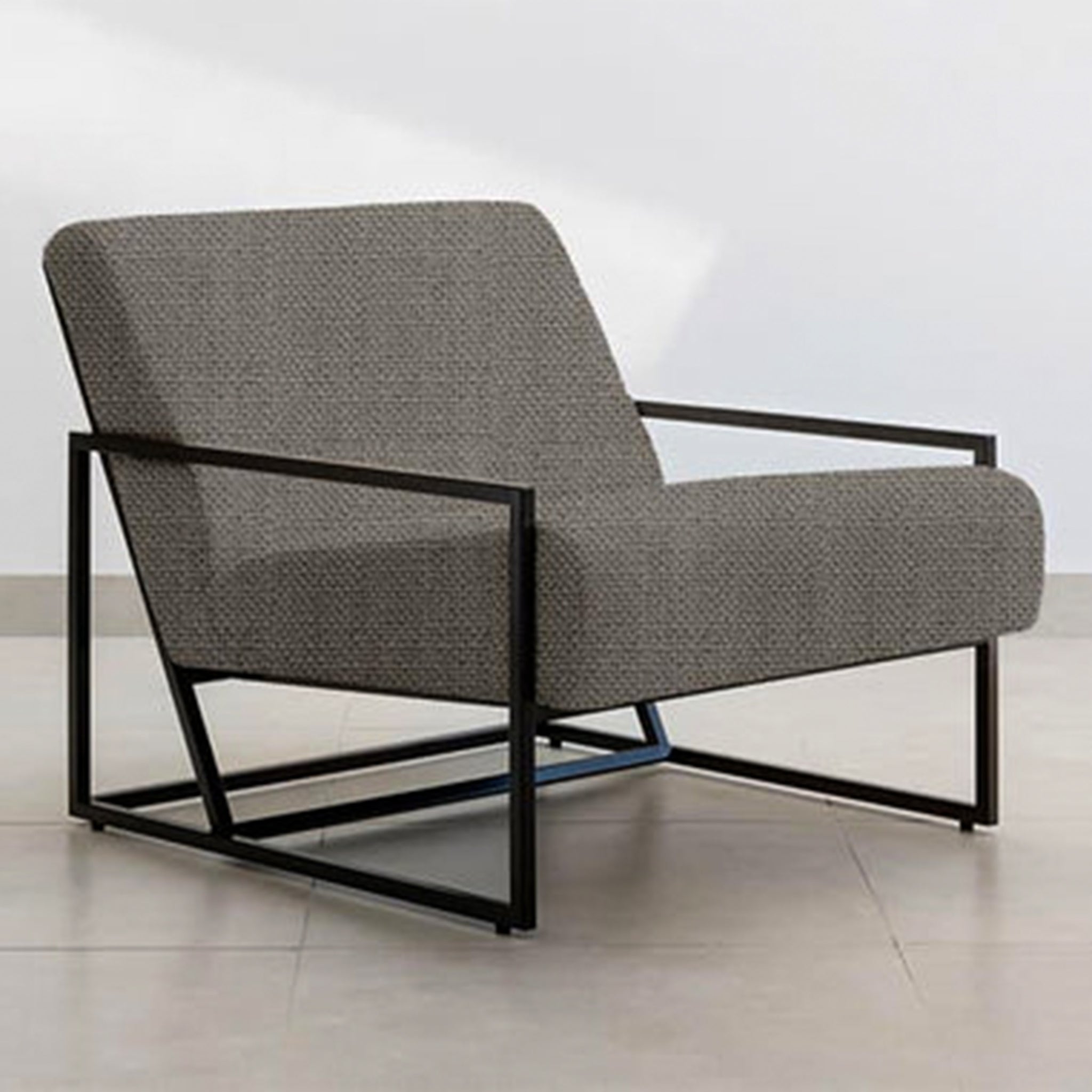 Side view of The Daphne Accent Chair showcasing its contemporary design and comfortable seating.