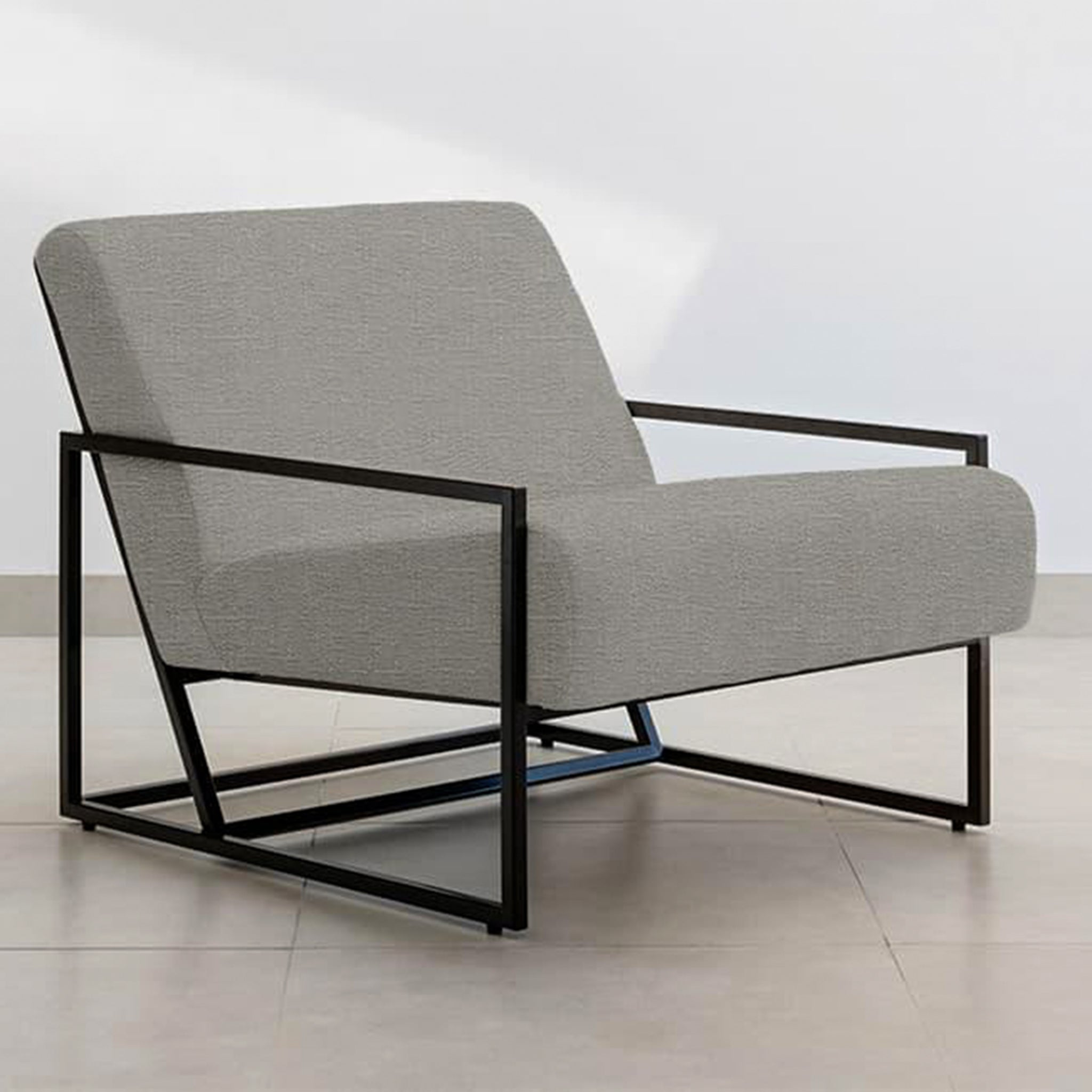 Side profile of The Daphne Accent Chair, emphasizing its geometric metal frame and deep seating.