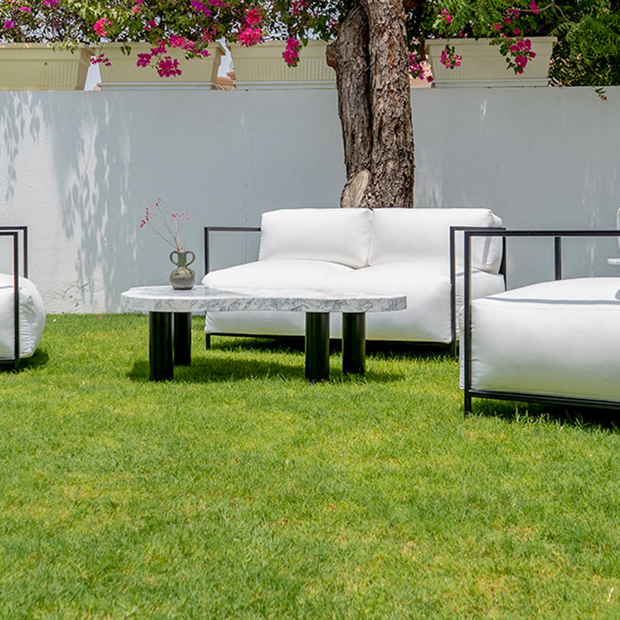 Relax in style on the Dexter, a modern three-seater outdoor sofa perfect for creating a comfortable patio retreat.