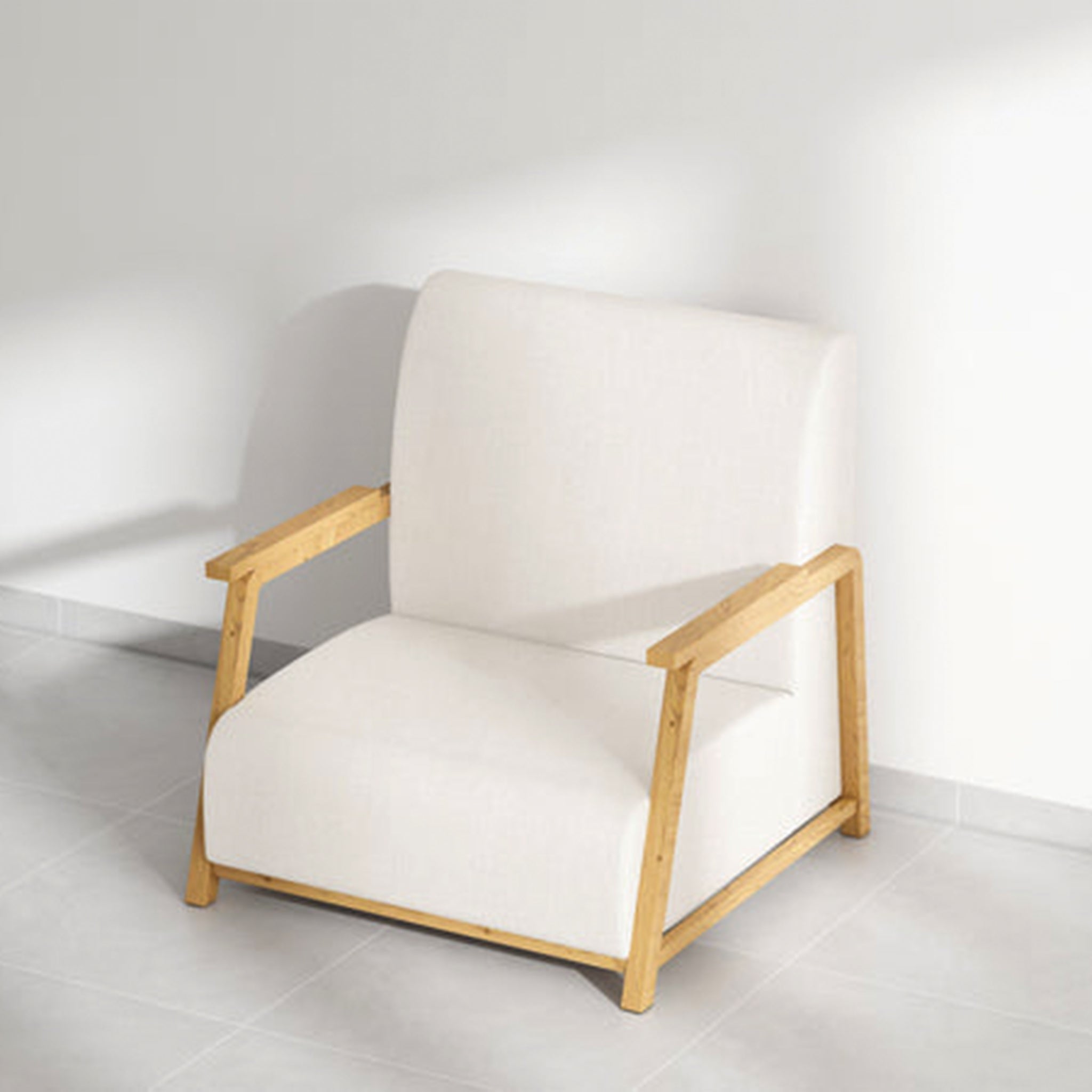 The Dixon Arm Accent Chair with light beige fabric and wooden frame, angled view.