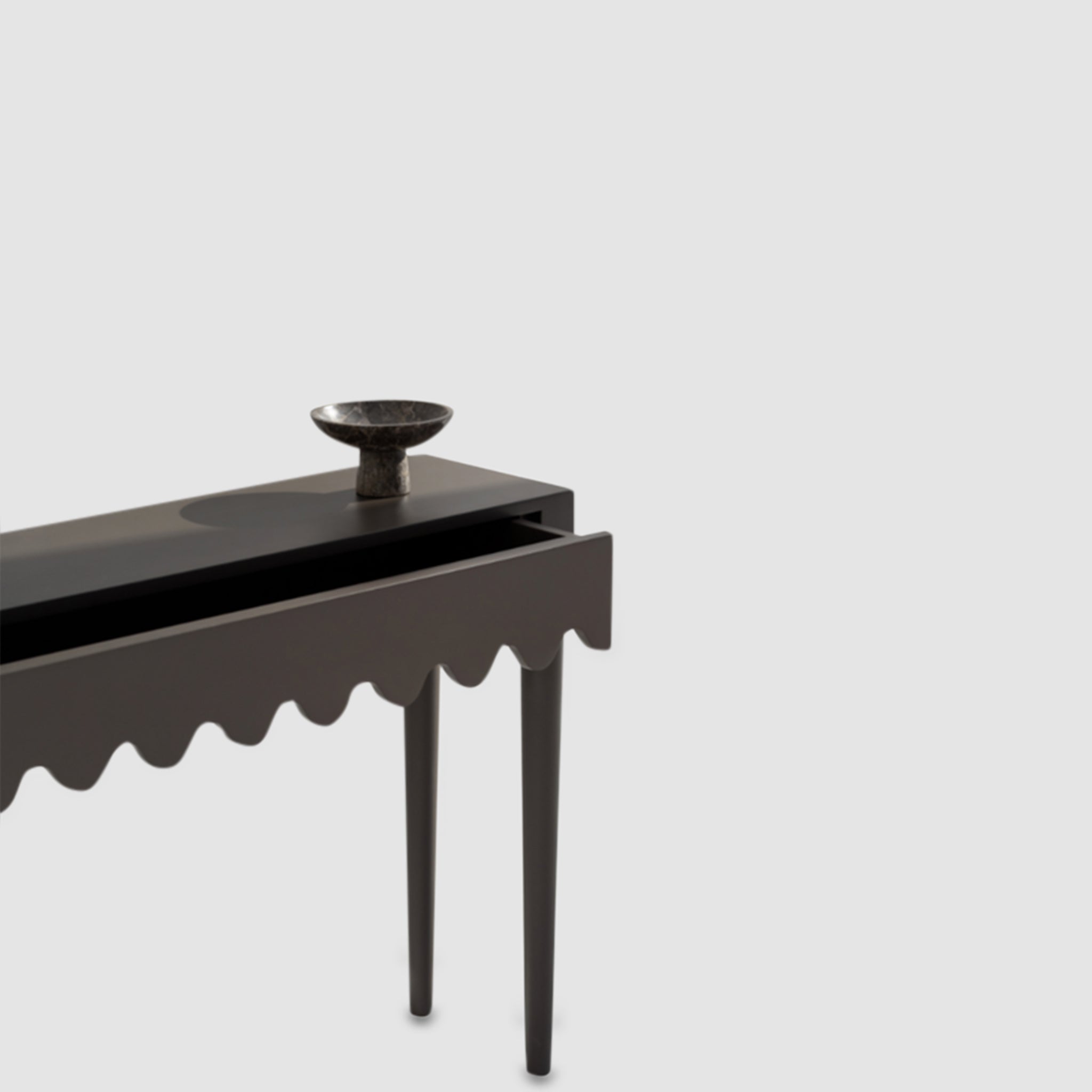 "Contemporary console table in black with a stylish wavy drawer design."