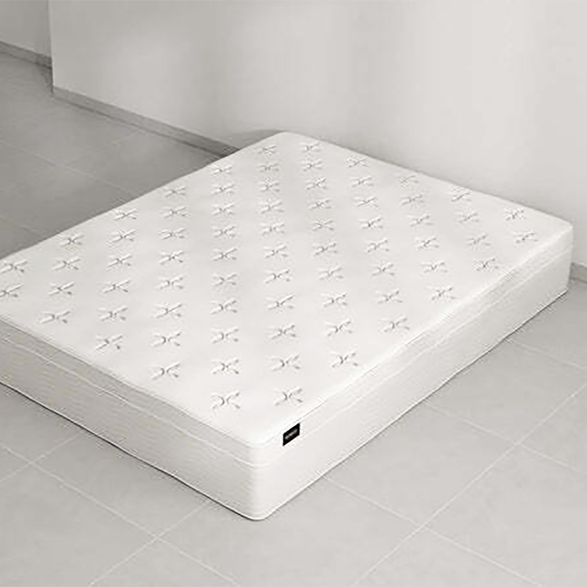 Plush, white EuroTop mattress with a knitted top sits on a tiled floor. The Douglas EuroTop Mattress offers 30cm of comfort and support.