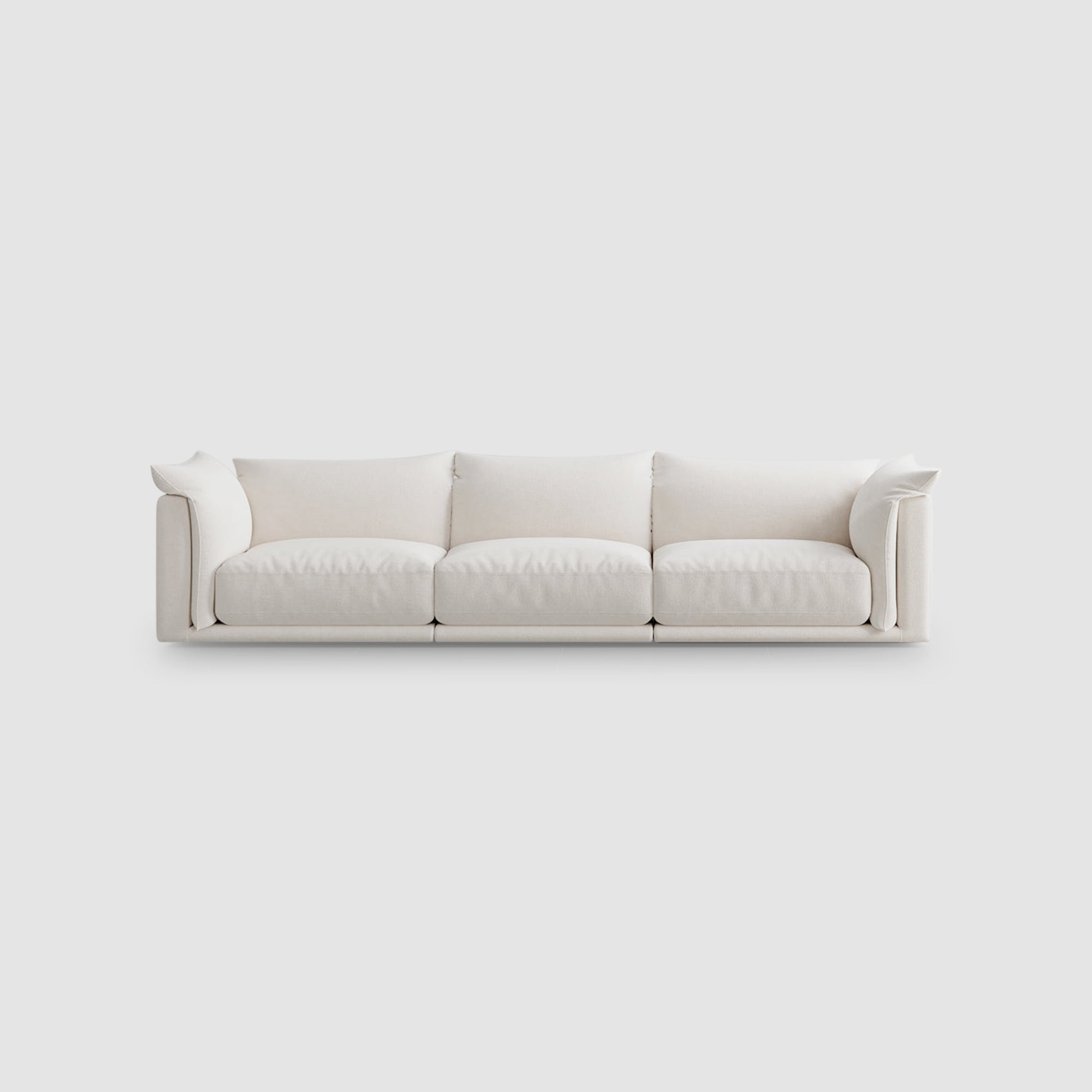 Elegant white three-seater sofa with plush cushions, perfect for minimalist and modern home interiors.
