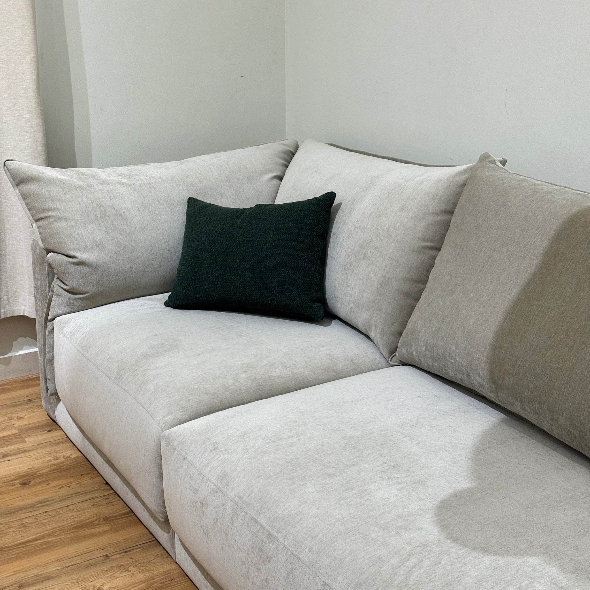 Gray plush Constance sofa in living room with wooden floor adds comfort and style