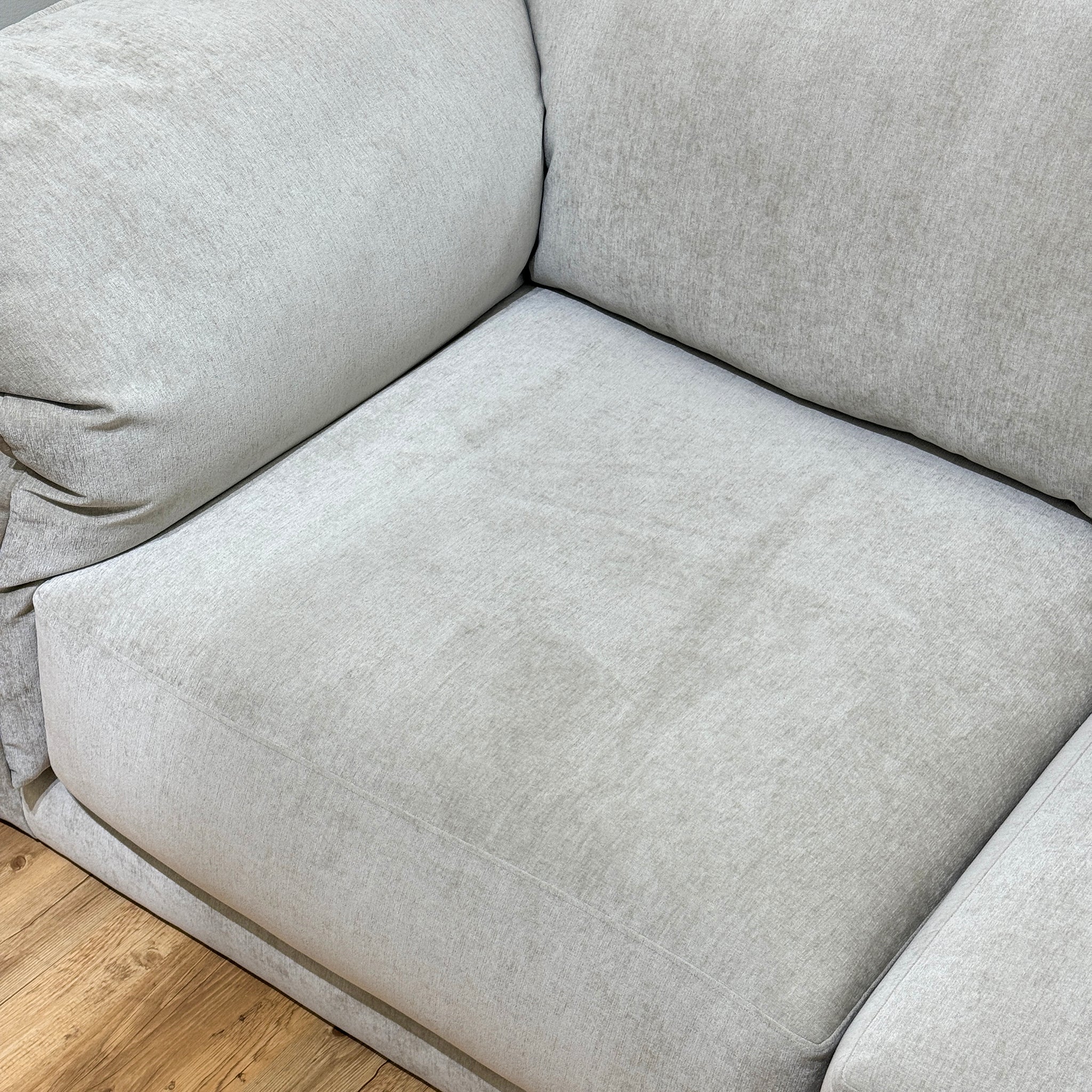 Close-up view of off-white Constance sofa back with button tufting, highlighting modern living room furniture