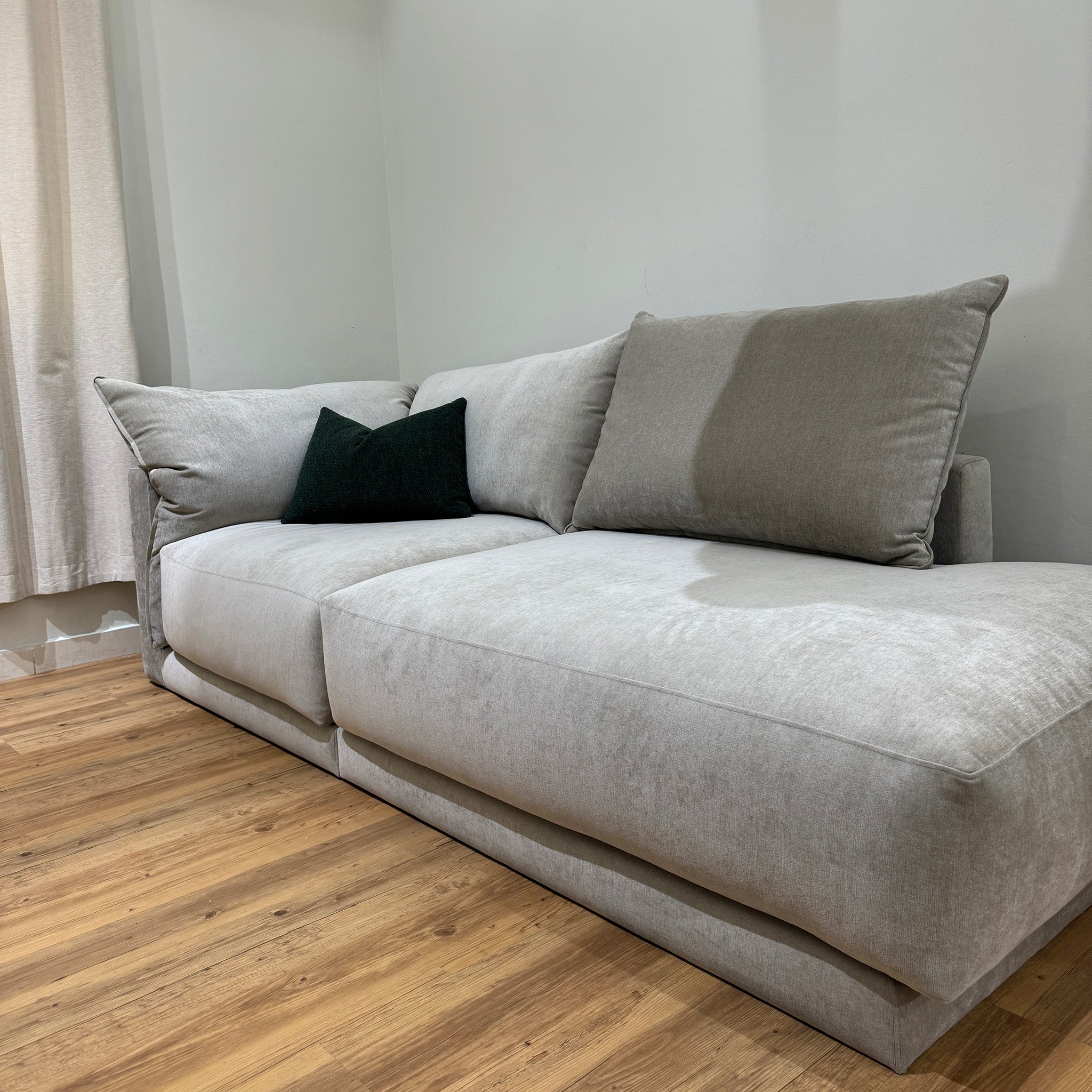 Gray plush Constance sofa in living room with hardwood floors for a comfortable, modern look