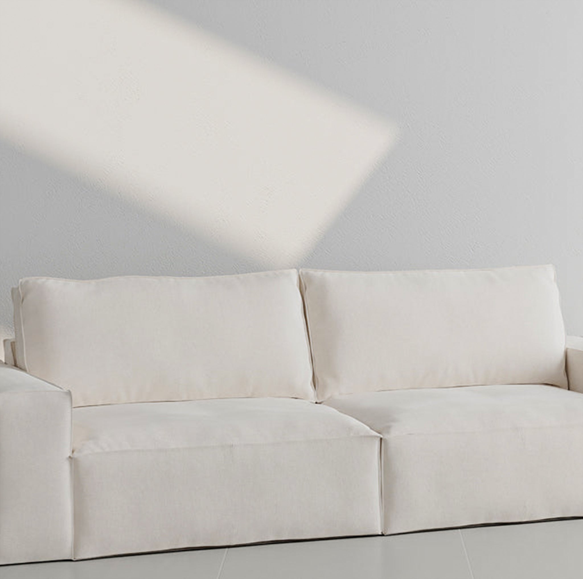 White three-seater sofa with plush cushions in a minimalistic room - buy sofa set Dubai